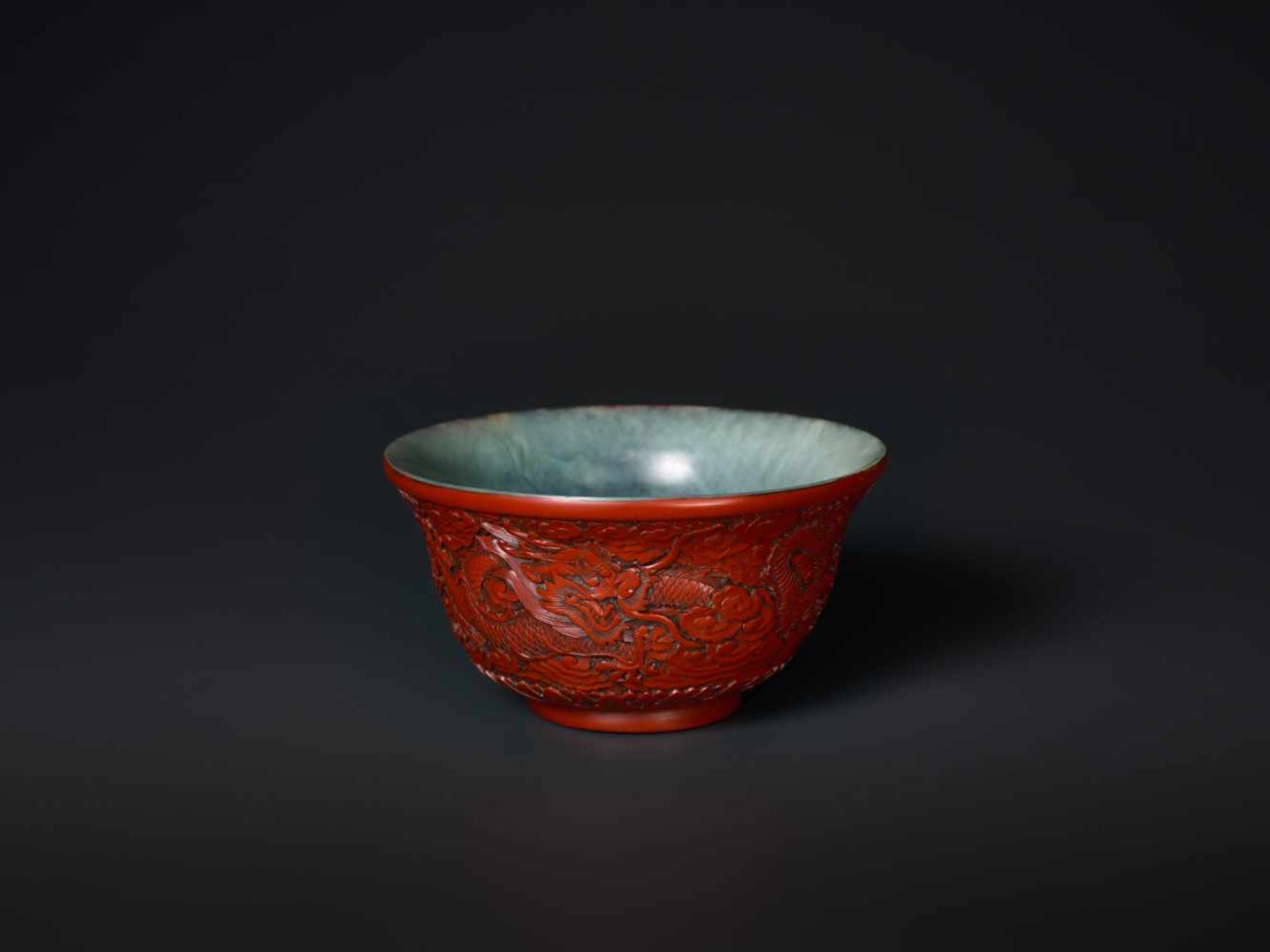 AN EXTREMELY RARE QIANLONG PERIOD CINNABAR LACQUER EMBELLISHED JADE BOWL Celadon and grey streaked