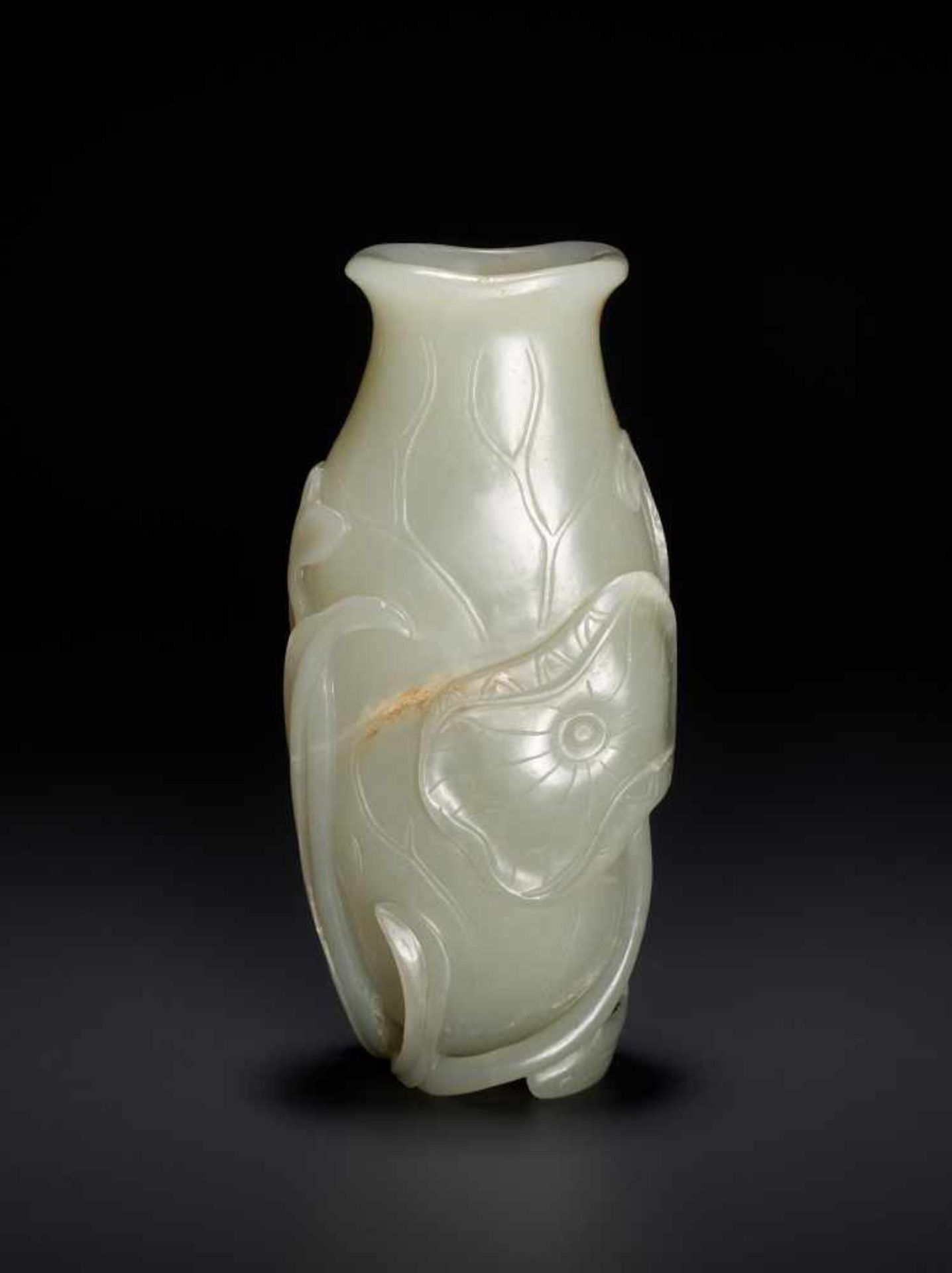 AN 18TH CENTURY CELADON AND RUSSET JADE LOTUS VASE Pale celadon with sparse russet inclusions,