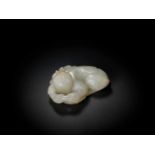 A WHITE JADE QING DYNASTY ‘BOY AND LOTUS’ PENDANT White jade of translucent quality with natural