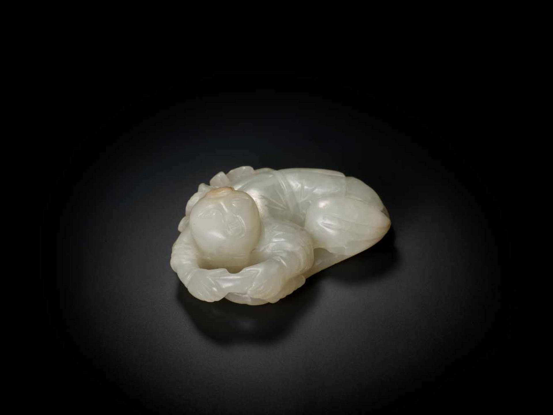 A WHITE JADE QING DYNASTY ‘BOY AND LOTUS’ PENDANT White jade of translucent quality with natural