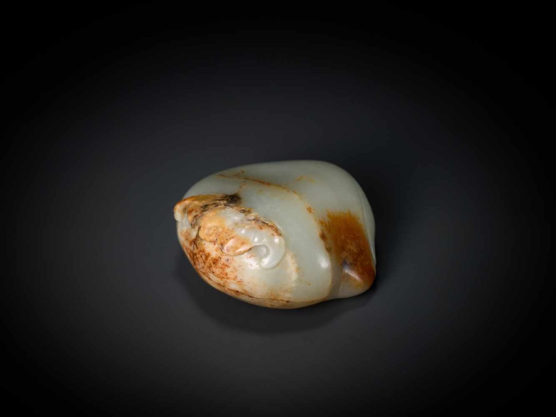 AN 18th CENTURY CELADON AND RUSSET JADE ‘PEACH AND BATS’ PEBBLE Light celadon color jade with russet