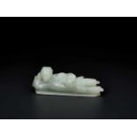 AN 18TH CENTURY CELADON JADE CARVING OF A RECLINING LADY Celadon Jade of an even color with very few