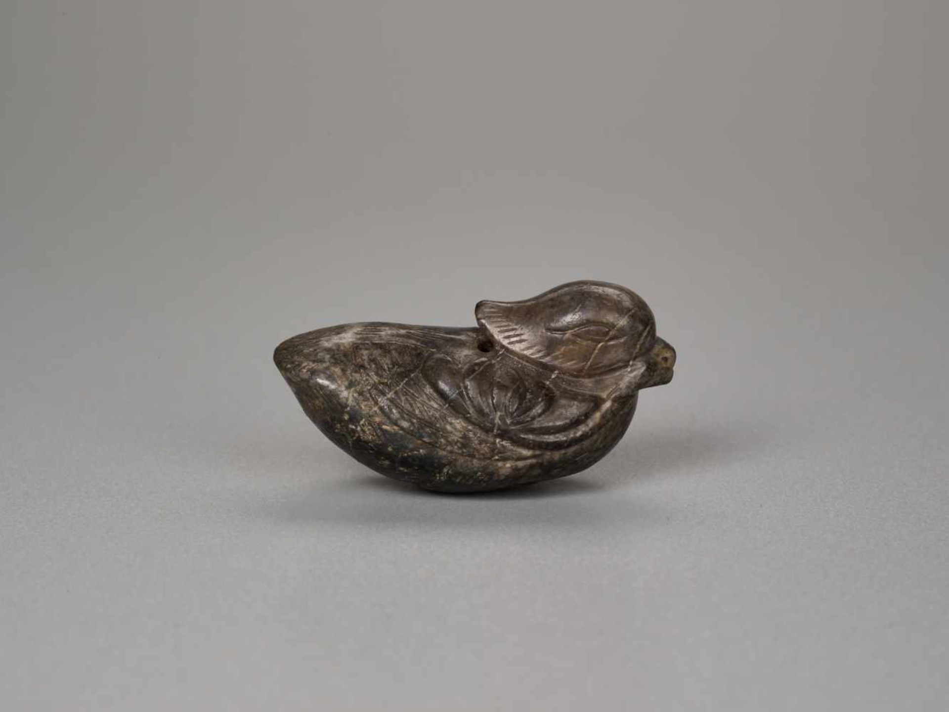 A YUAN / MING DYNASTY MOTTLED JADE TOGGLE OF A MANDARIN DUCK Brown and black mottled jade, smooth - Bild 2 aus 7