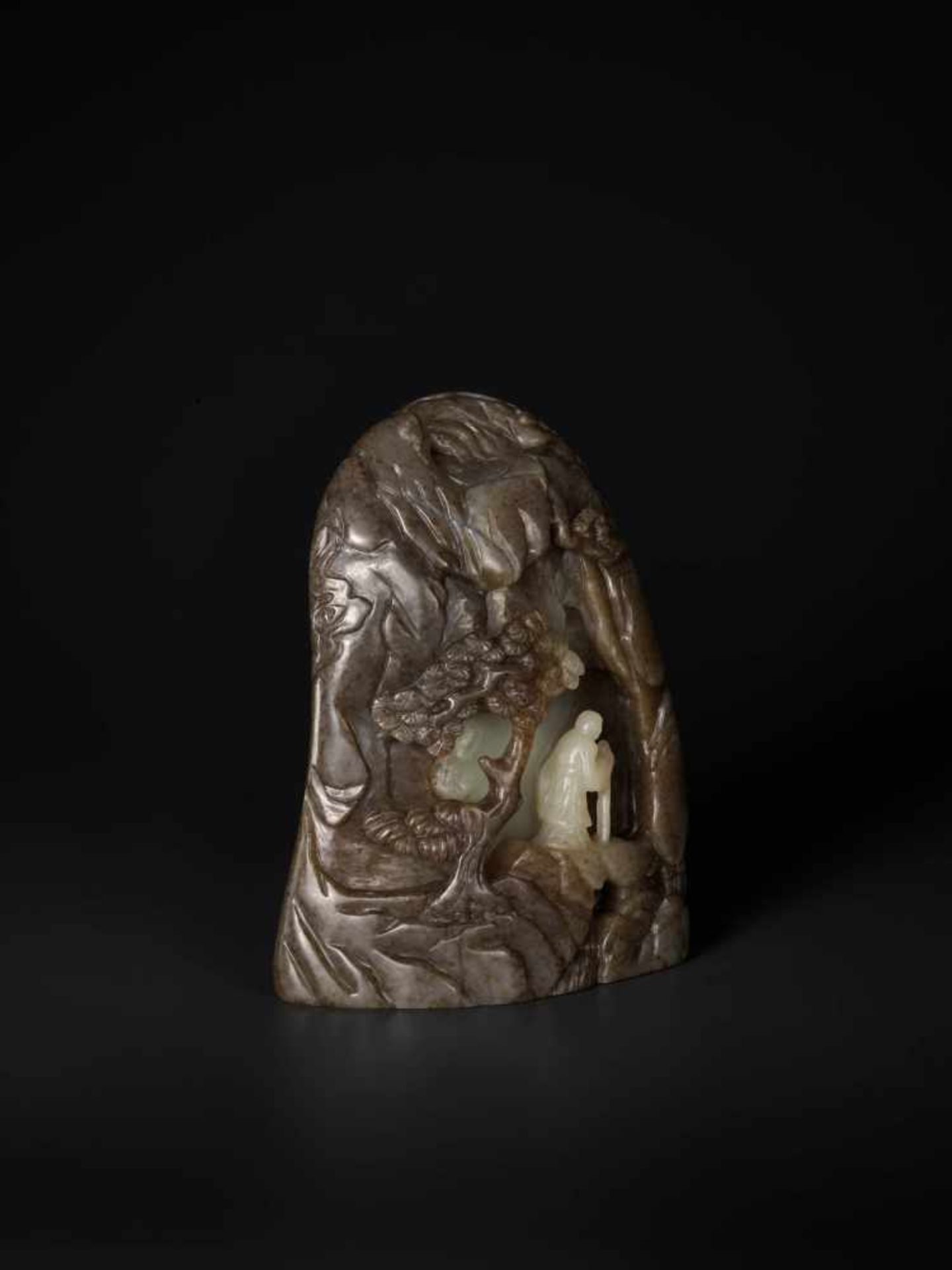 A LARGE BROWN, CELADON AND WHITE JADE MOUNTAIN BOULDER, QING DYNASTY Celadon and brown jade with