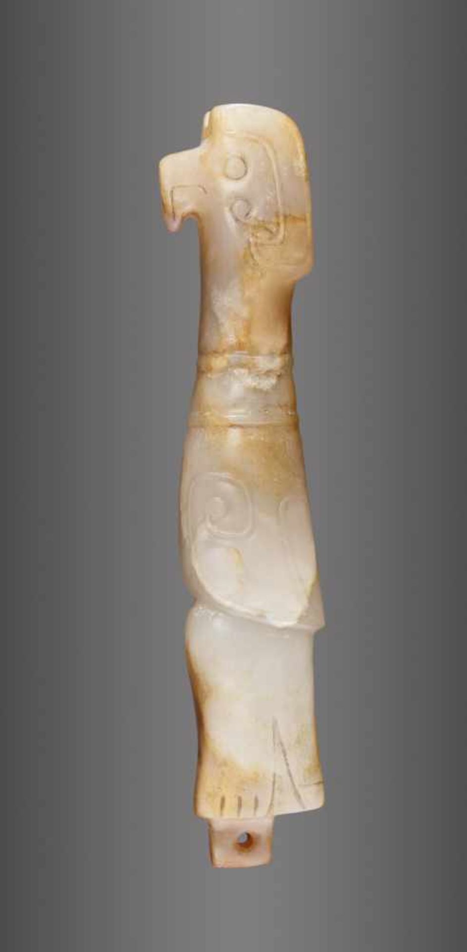 AN EXQUISITE FINIAL IN WHITE JADE CARVED AS AN ELONGATED BIRD IN PROFILE Jade. China, Late Shang