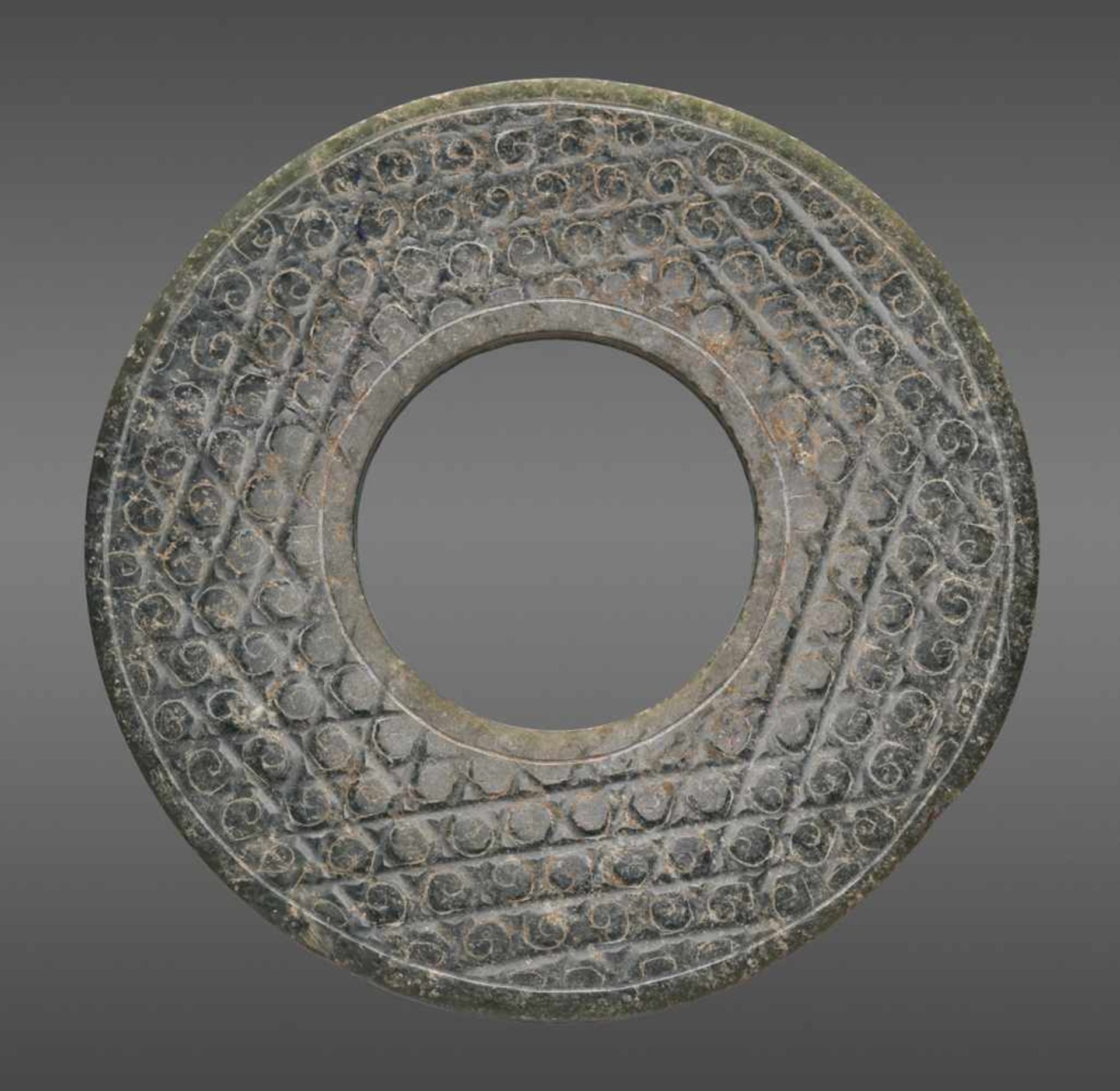 A SHINY GREEN DISC WITH A DELICATE PATTERN OF INCISED SCROLLS Jade. China, Han Dynasty, 2nd - Image 3 of 10