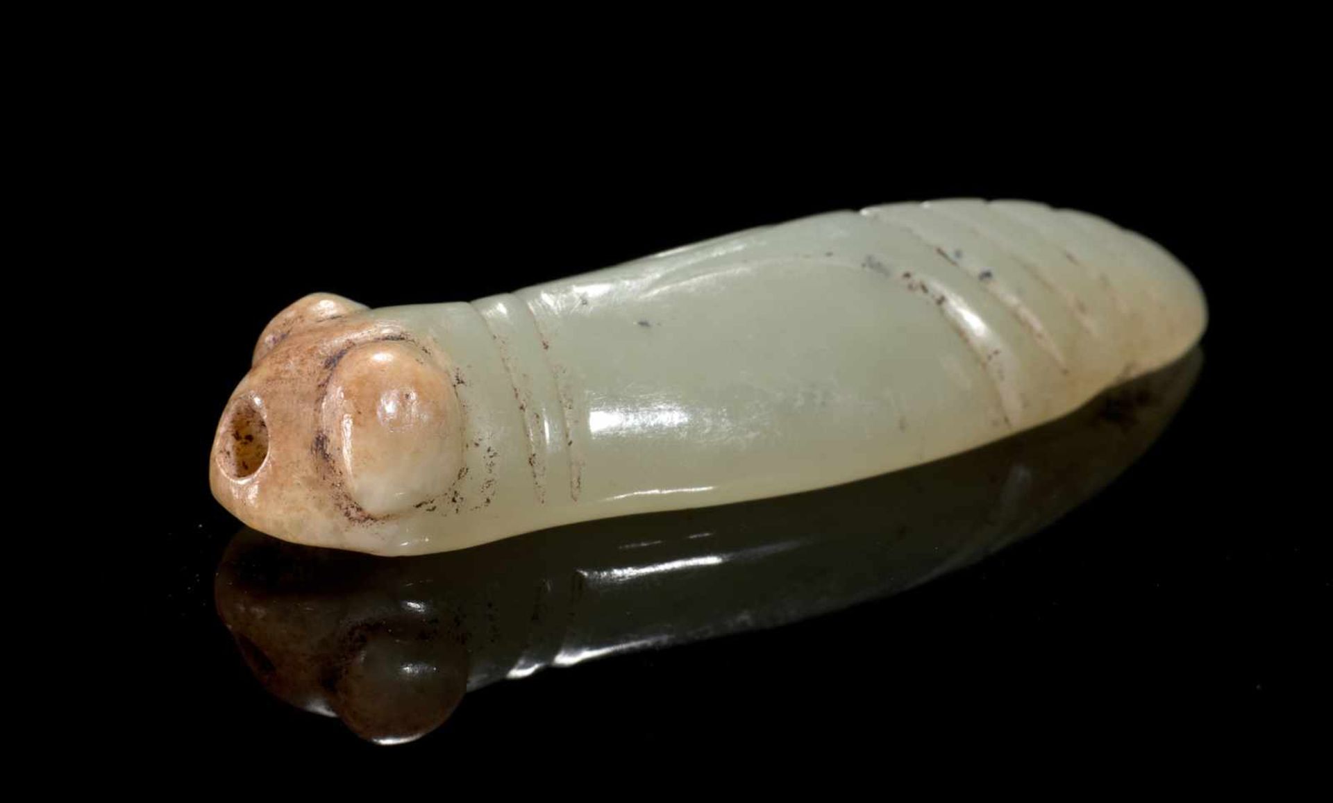 A TINY, HIGHLY POLISHED LATE SHANG CICADA WITH BULGING EYES CARVED IN LIGHT GREEN JADE Jade.