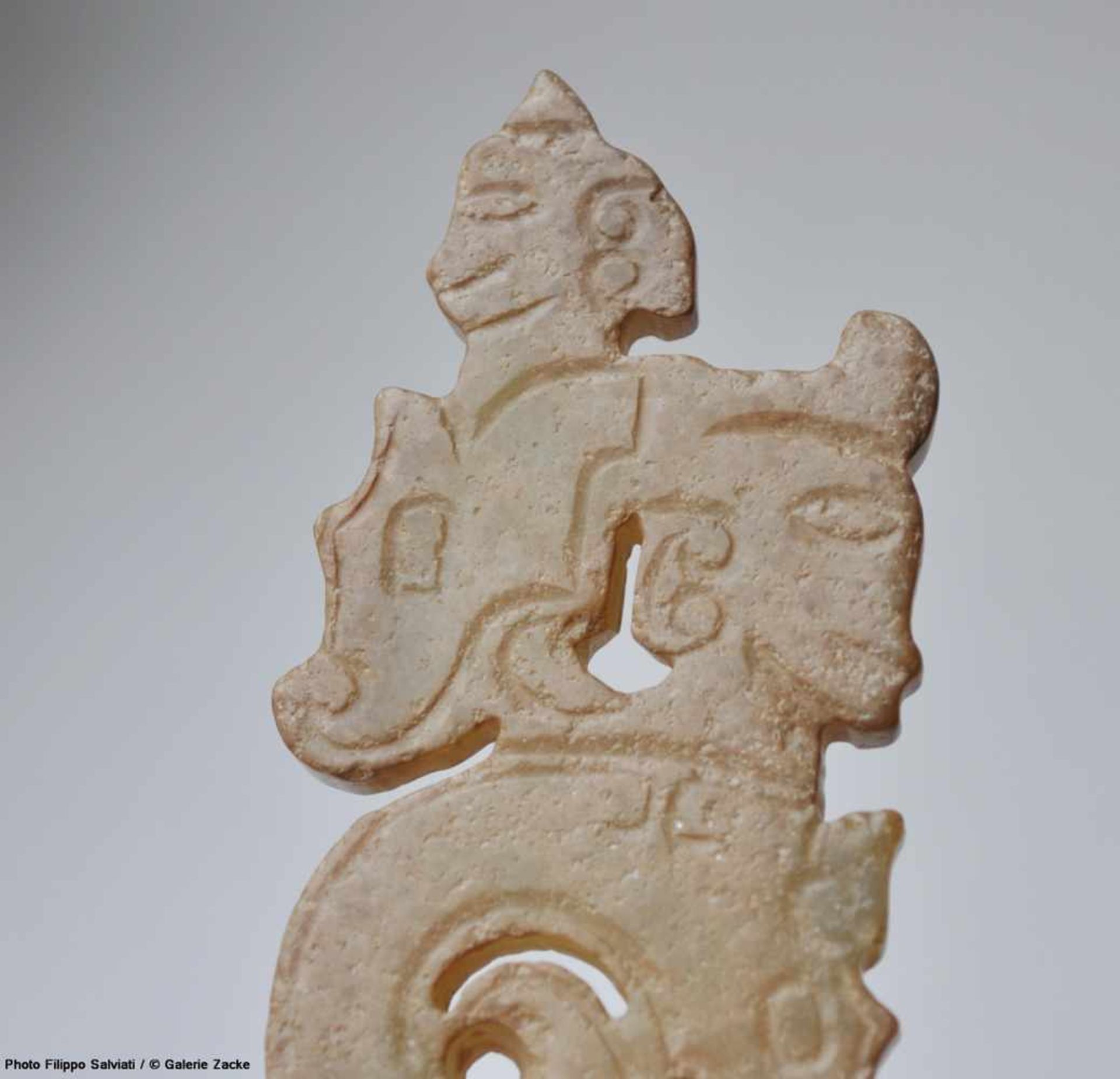 A THIN, FLAT ORNAMENT WITH A COMPOSITE PATTERN OF HUMAN HEADS AND DRAGONS Jade. China, Western Zhou, - Image 9 of 11