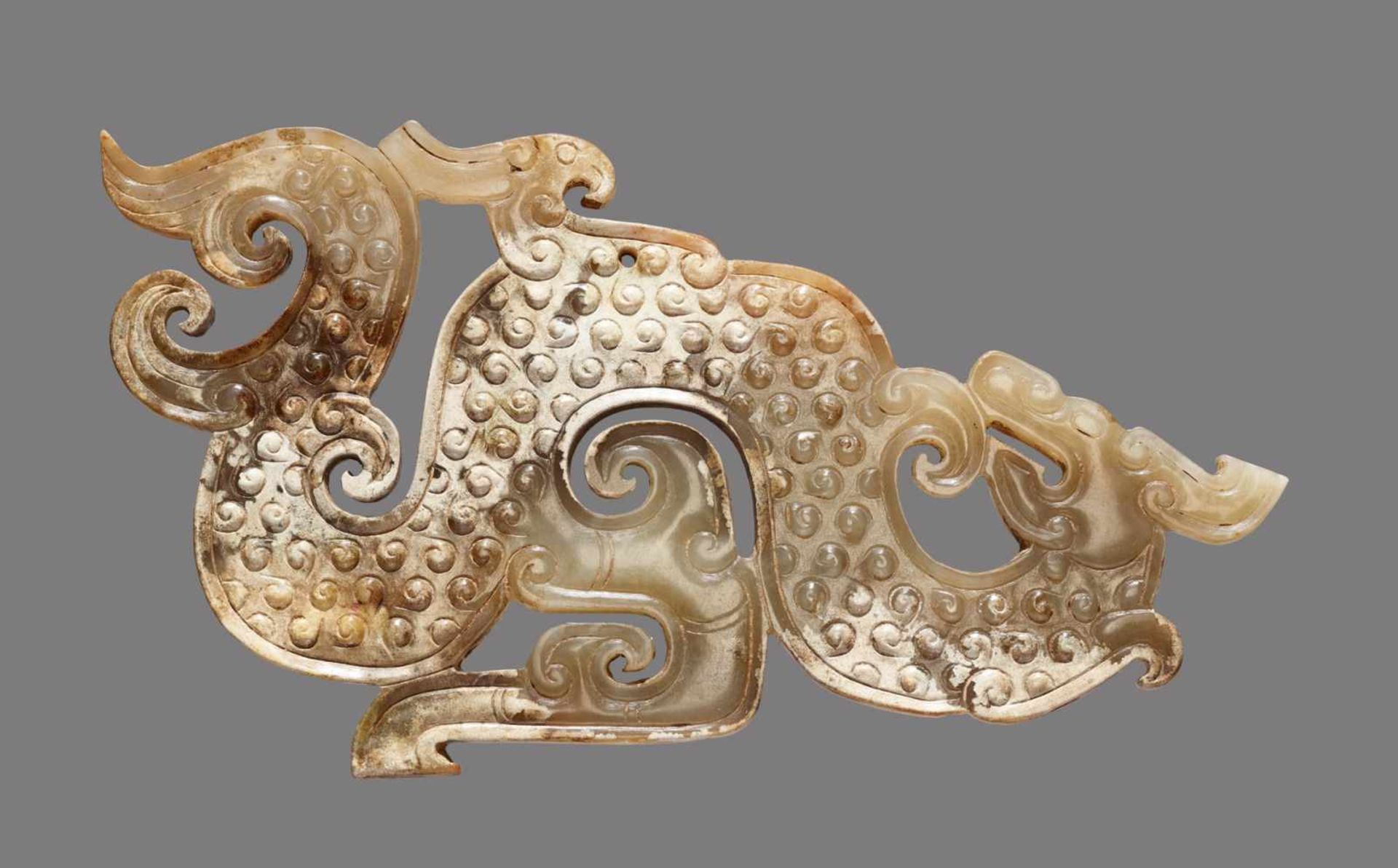 A SINUOUS S-SHAPED DRAGON WITH A PHOENIX AND CURLED APPENDAGES Jade. China, Eastern Zhou, 5th -