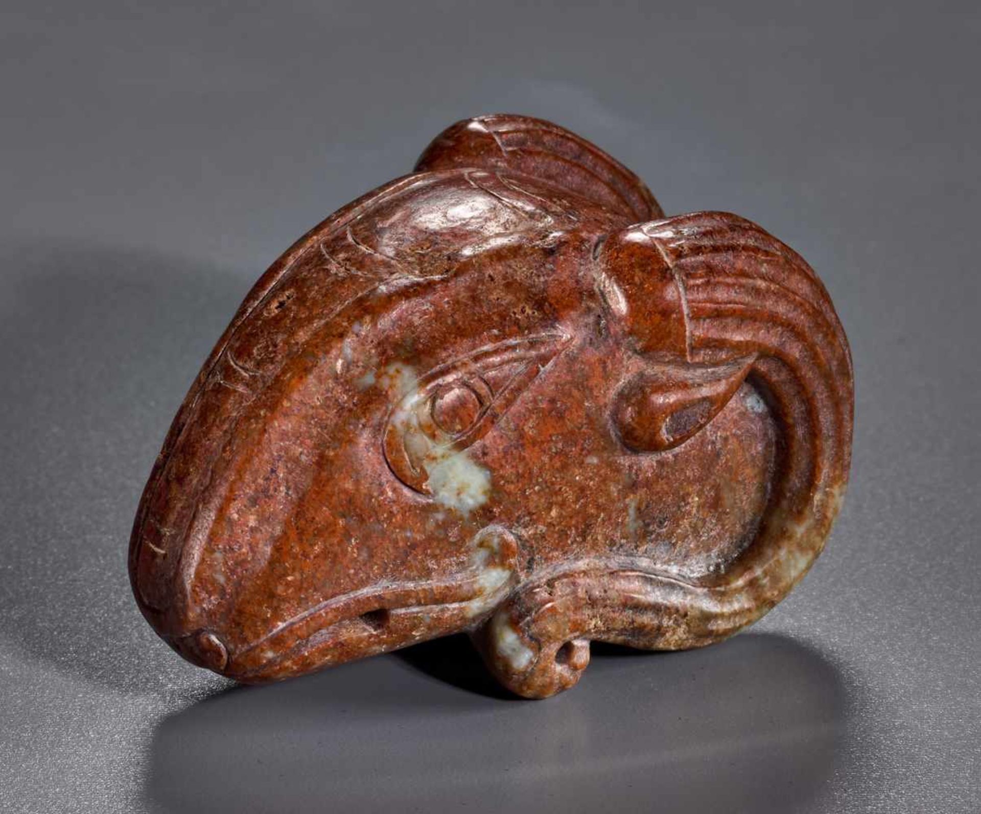 AN EXCEPTIONAL HAN PERIOD RAM’S HEAD CARVED IN THE ROUND IN JASPER-LIKE JADE Jade. China, Han