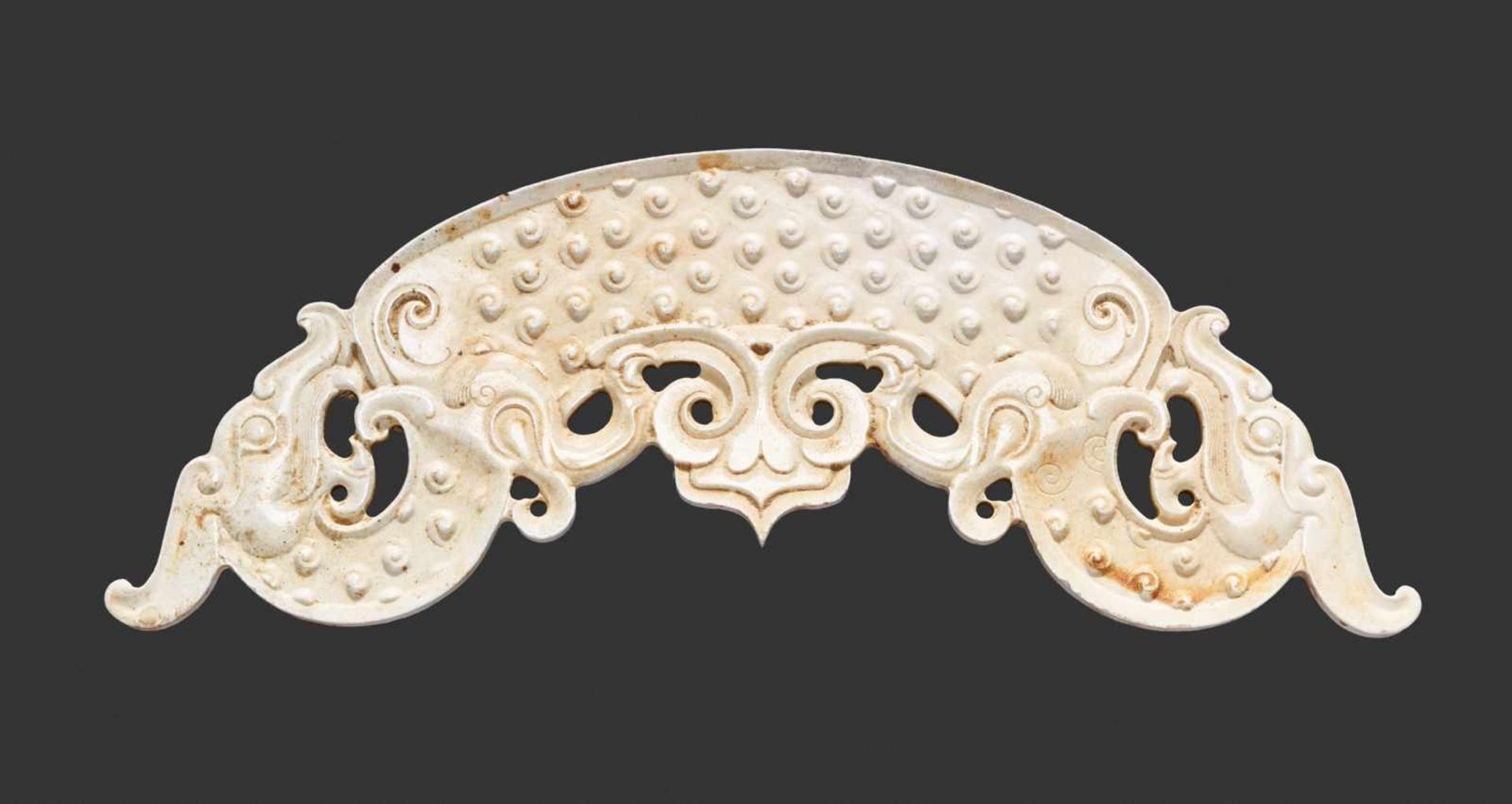 A REMARKABLE HUANG WITH FINELY DETAILED SINUOUS DRAGONS IN IVORY-LIKE JADE Jade. China, Eastern