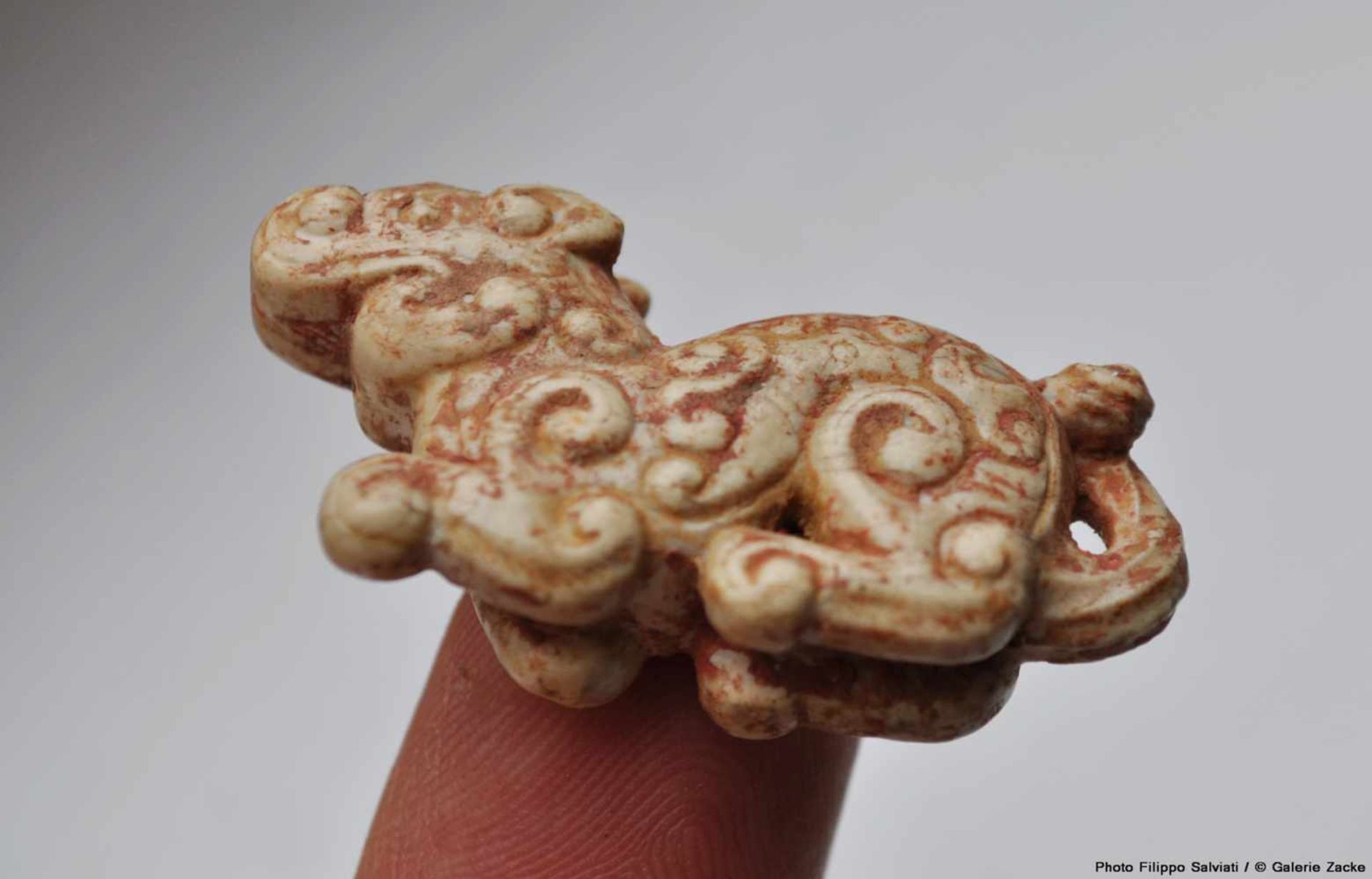 A MINISCULE CROUCHING ANIMAL WITH AN INTRICATE PATTERN OF CARVED CURLS Jade. China, Eastern Zhou, - Image 10 of 12