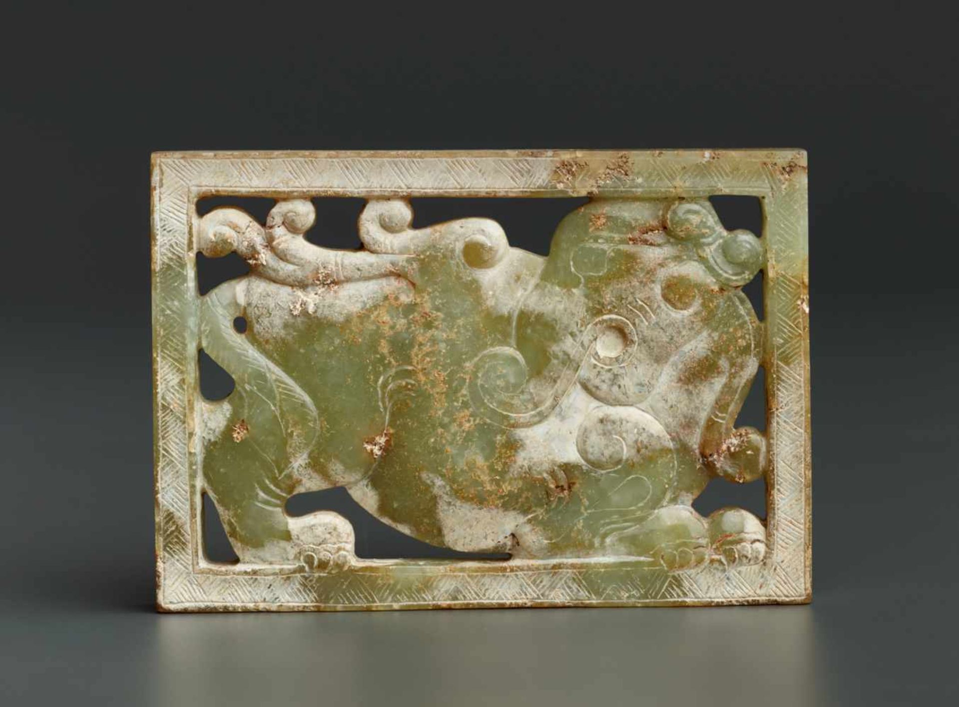 A RECTANGULAR PLAQUE IN CELEADON COLOURED JADE WITH AN ELEPHANT CARVED IN OPENWORK Jade. China,