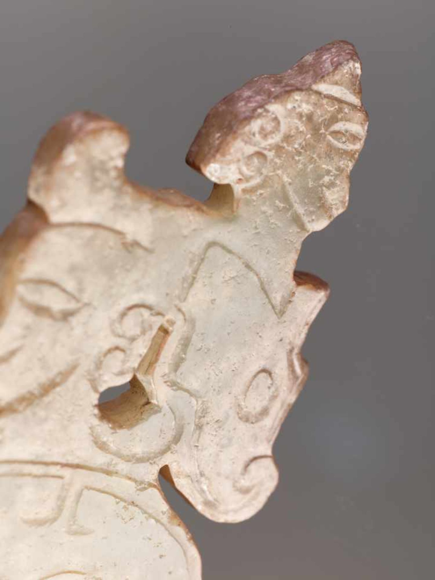 A THIN, FLAT ORNAMENT WITH A COMPOSITE PATTERN OF HUMAN HEADS AND DRAGONS Jade. China, Western Zhou, - Image 7 of 11