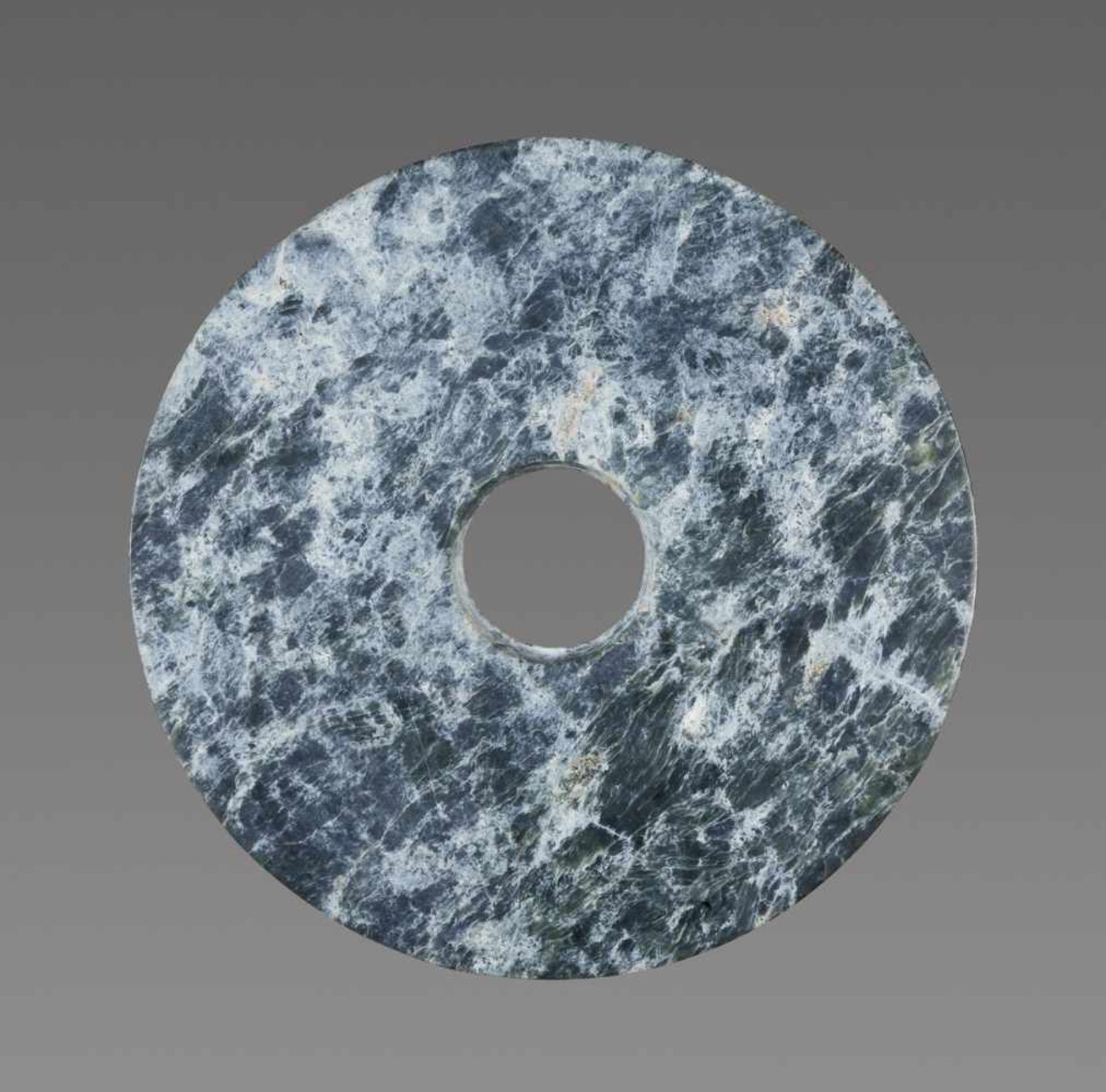 A RICHLY TEXTURED NEOLITHIC BI DISC IN GREEN JADE WITH A STRIKING MARBLE-LIKE PATTERN Jade. China,