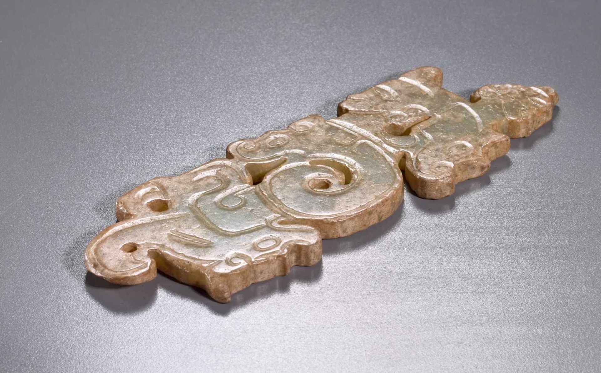 A THIN, FLAT ORNAMENT WITH A COMPOSITE PATTERN OF HUMAN HEADS AND DRAGONS Jade. China, Western Zhou, - Image 6 of 11