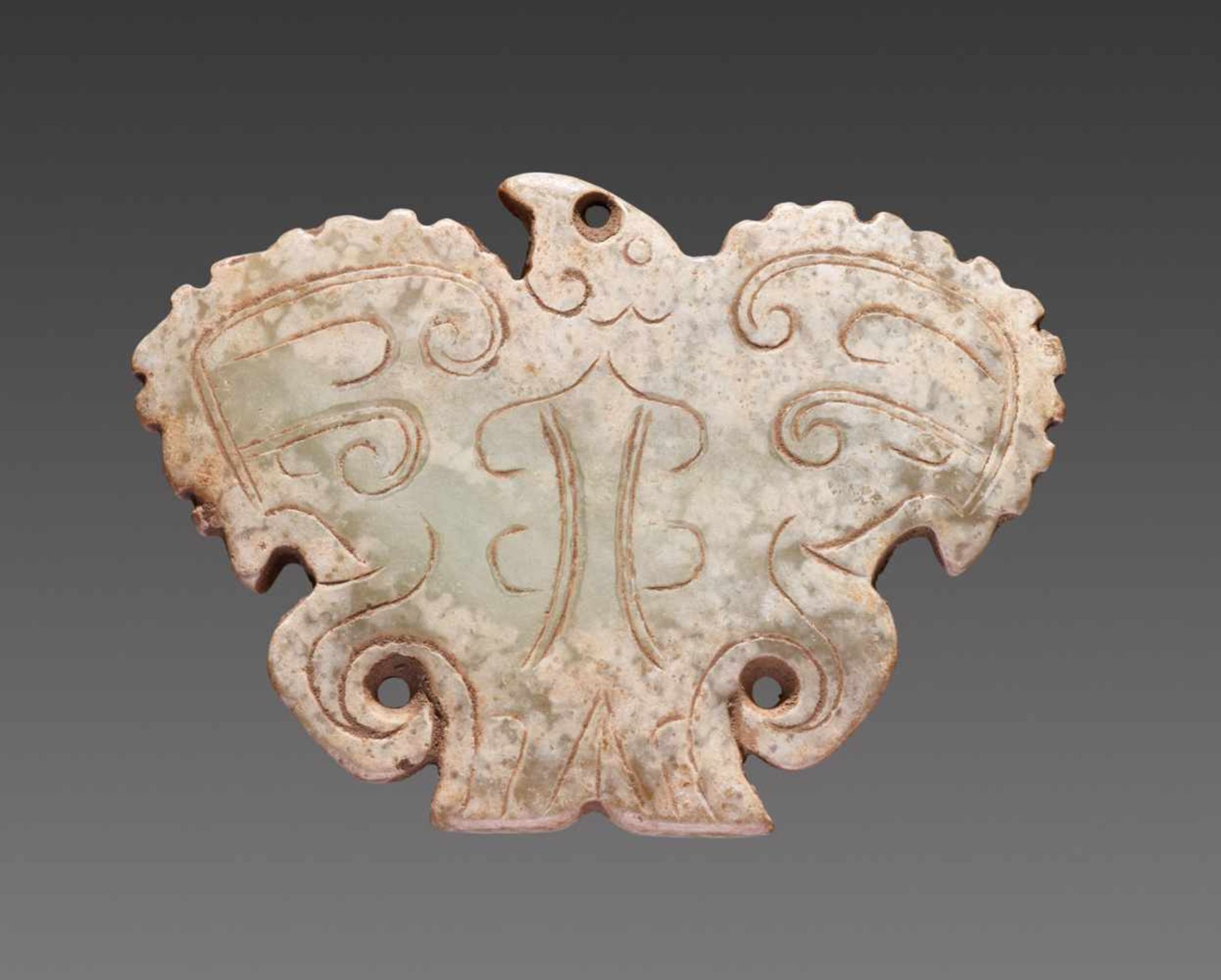 A POWERFUL CARVING OF A HAWK WITH OUTSTRETCHED SCALLOPED WINGS DECORATED WITH INCISED CURLS Jade.