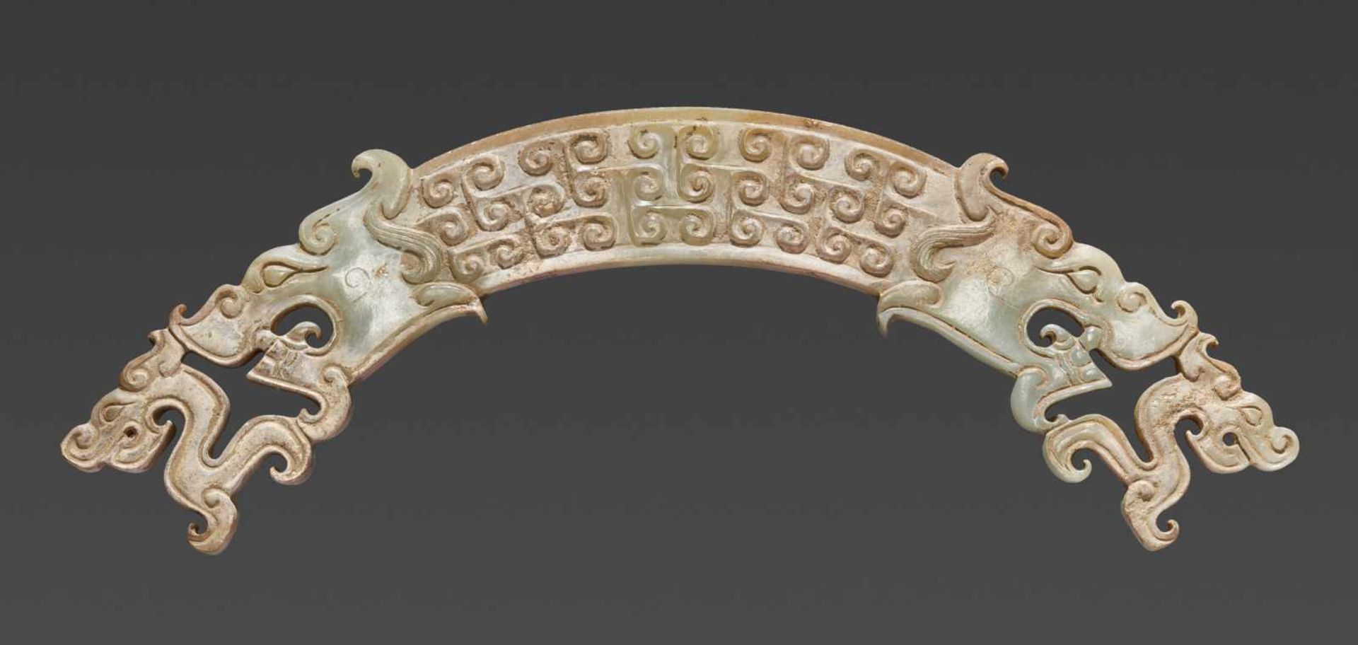 A UNIQUE HUANG ARCHED ORNAMENT DECORATED WITH DRAGONS IN OPENWORK ON THE SIDES Jade. China,