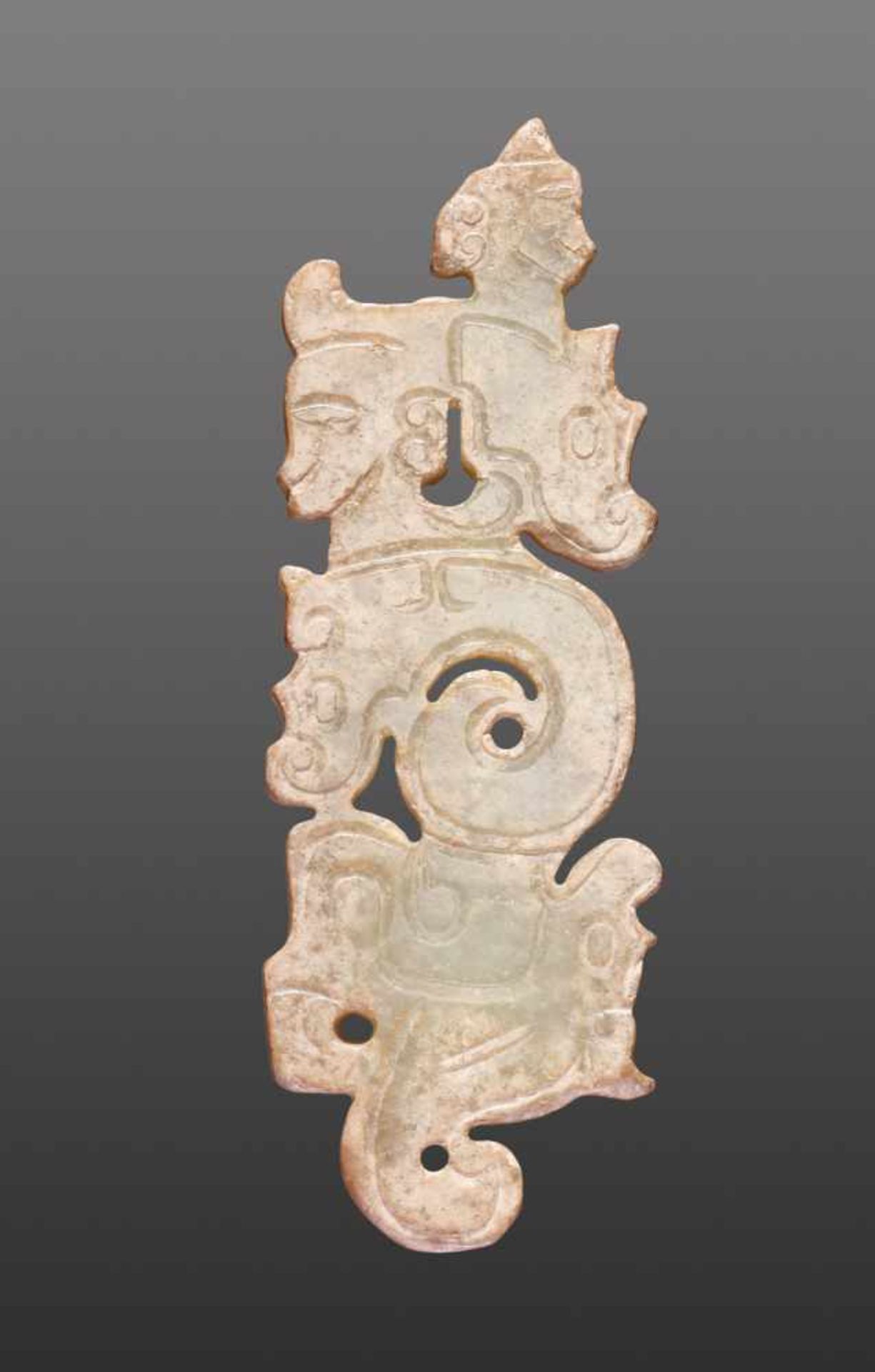 A THIN, FLAT ORNAMENT WITH A COMPOSITE PATTERN OF HUMAN HEADS AND DRAGONS Jade. China, Western Zhou, - Image 4 of 11