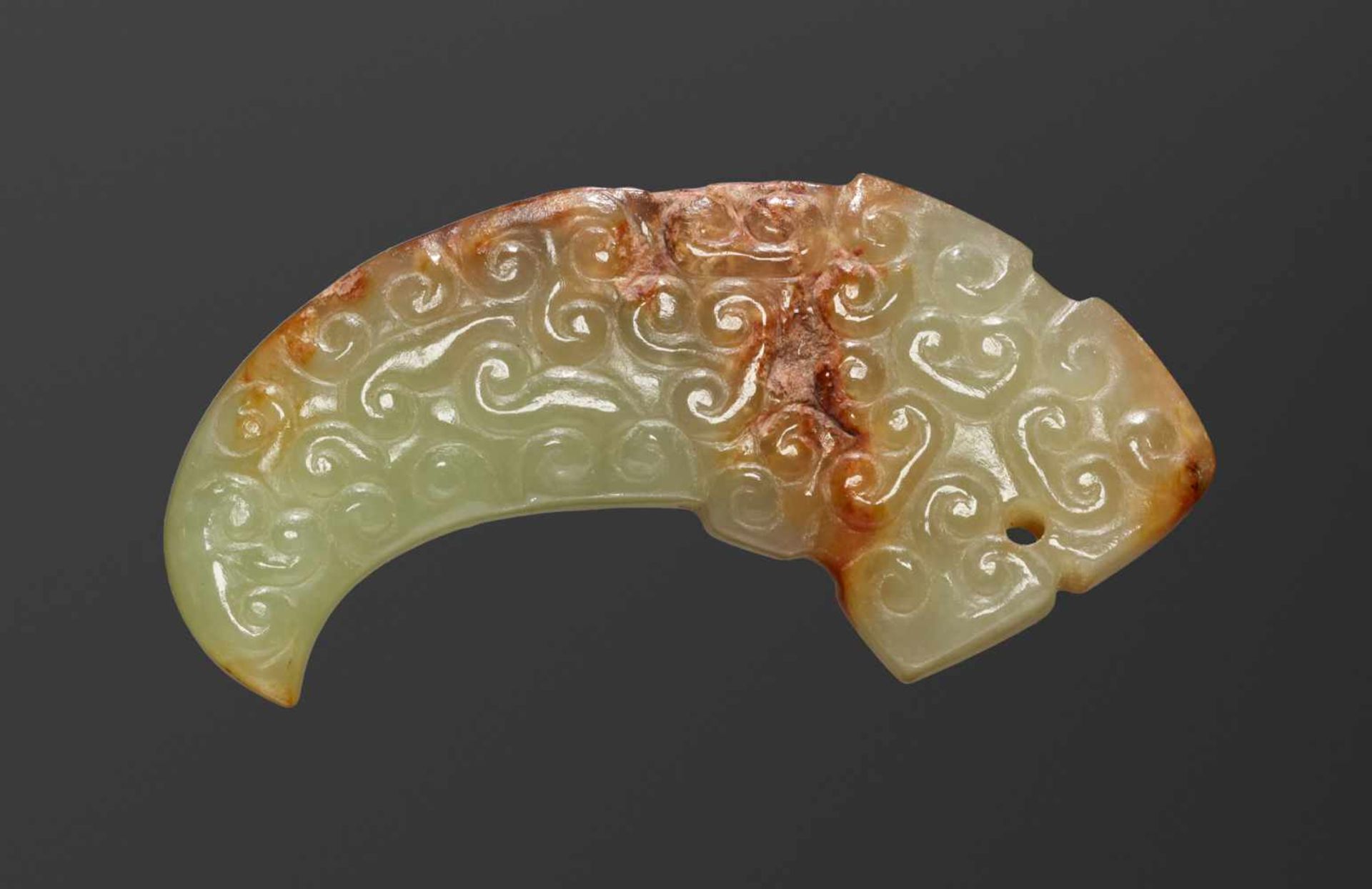 A FINE TINY DRAGON-SHAPED PENDANT IN HIGHLY POLISHED LIGHT GREEN JADE Jade. China, Eastern Zhou,