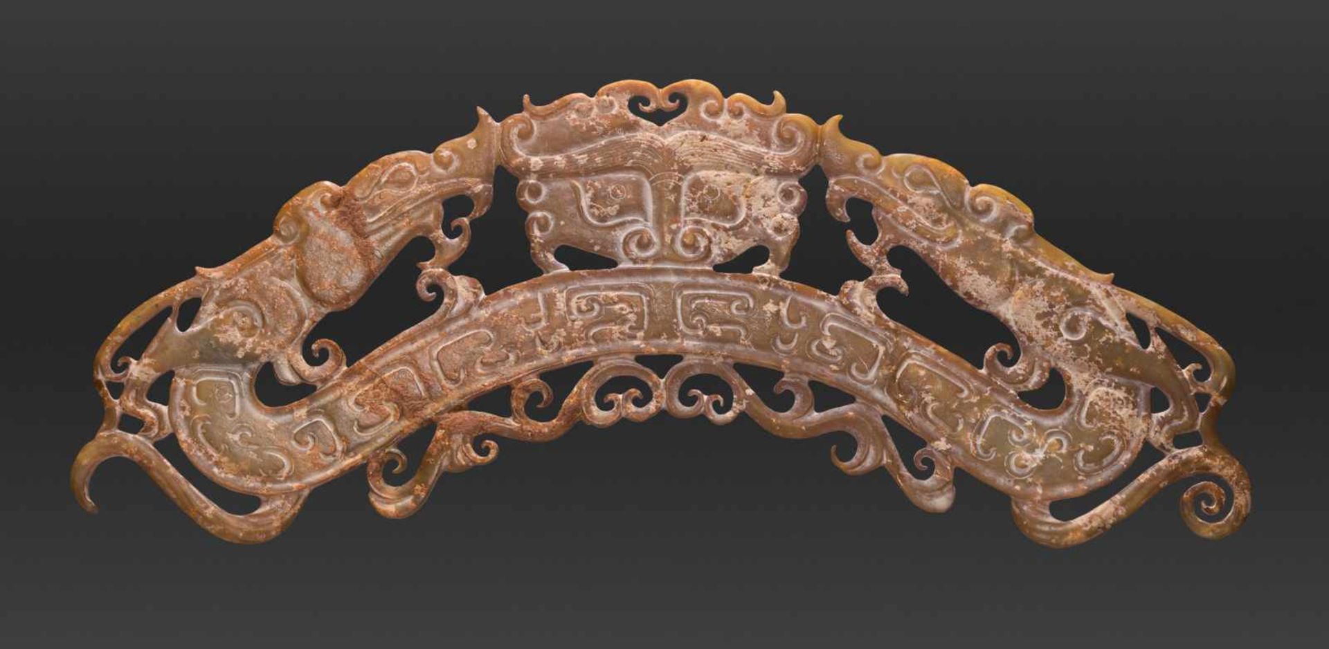 AN IMPRESSIVE ARCHED ORNAMENT DECORATED IN OPENWORK WITH DRAGONS AND A TAOTIE MASK Jade. China, Late