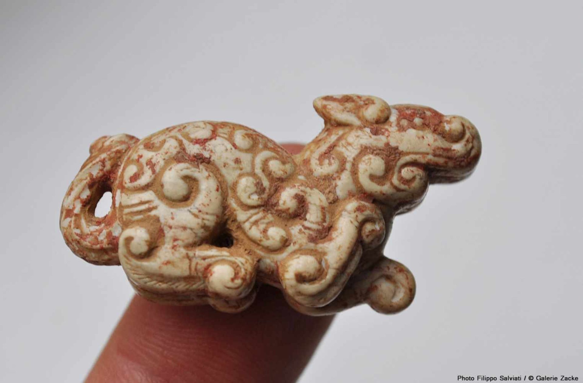 A MINISCULE CROUCHING ANIMAL WITH AN INTRICATE PATTERN OF CARVED CURLS Jade. China, Eastern Zhou, - Image 9 of 12