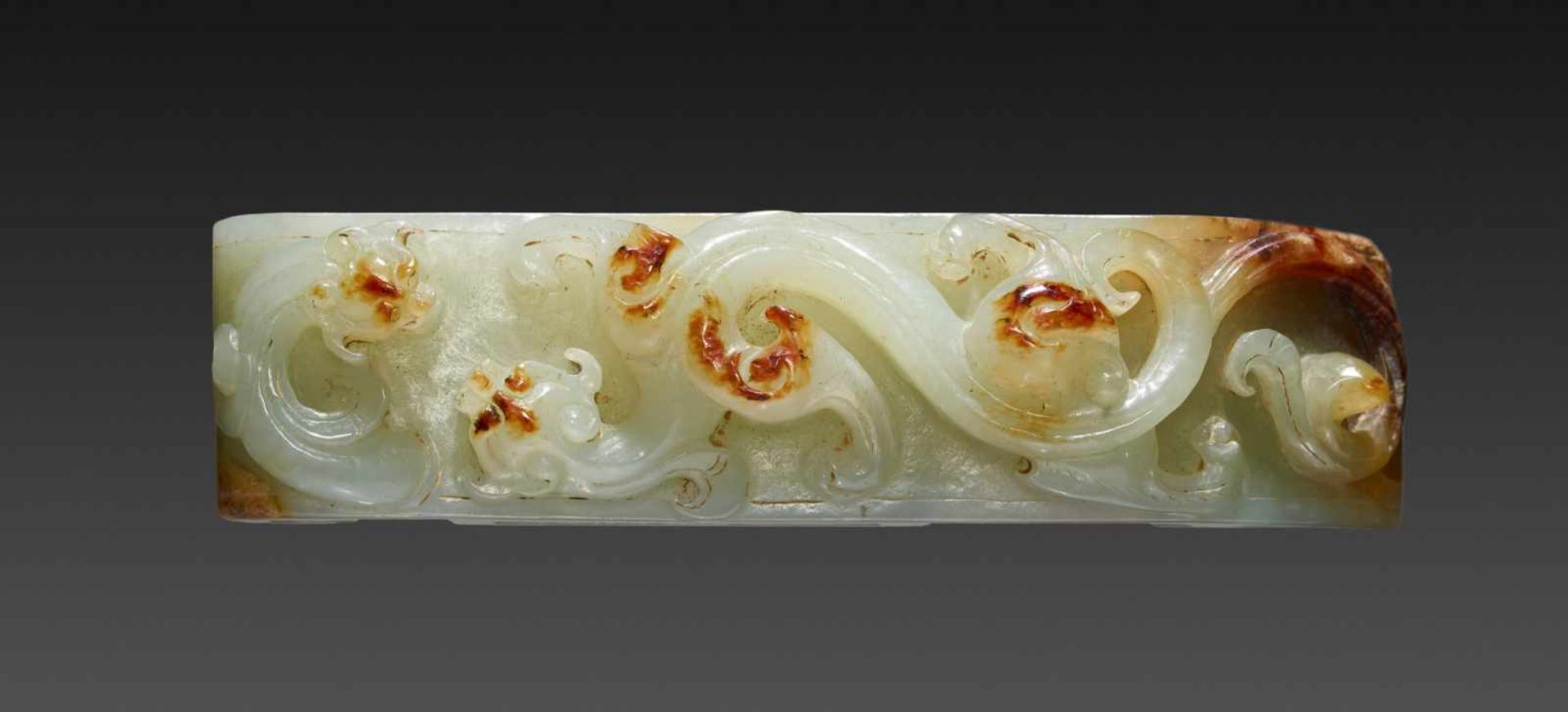 A SPLENDID SUI SCABBARD SLIDE IN HIGHLY POLISHED CELADON GREEN JADE WITH HORNLESS CHI DRAGONS CARVED