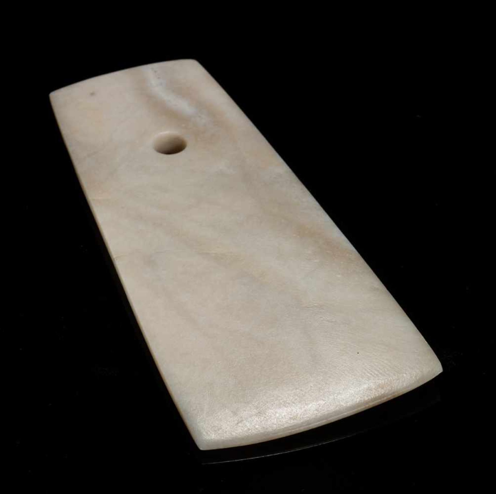 A SMOOTH AND ATTRACTIVE QIJIA CULTURE BLADE OF TRAPEZOIDAL FORM IN WHITE JADE Jade. China, Early