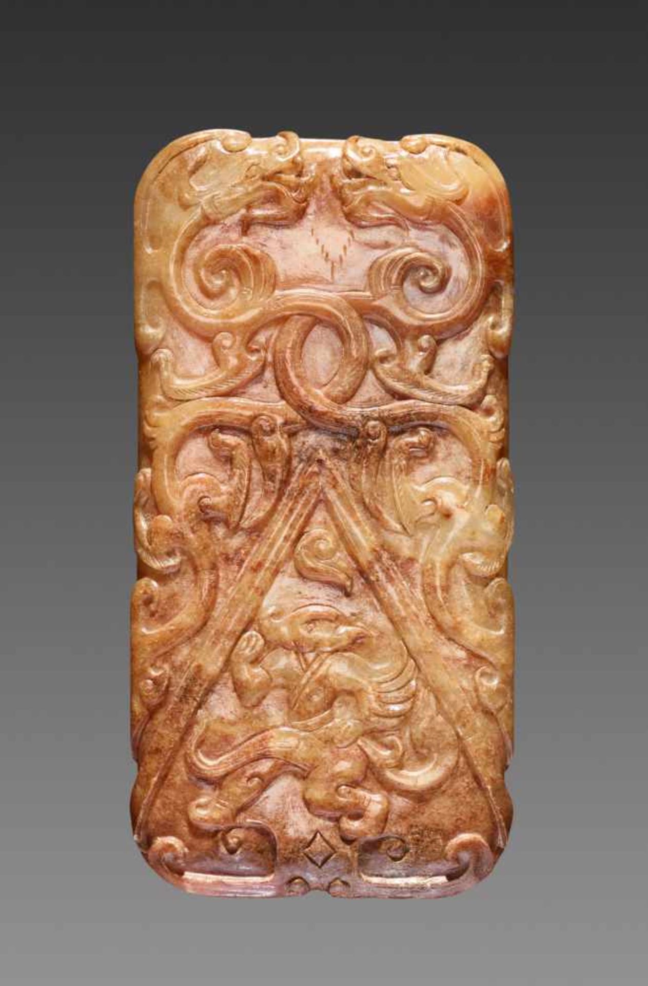 A RARE AND EXQUISITE HAN DYNASTY RECTANGULAR PENDANT IN WHITE AND RUSSET JADE CARVED WITH DRAGONS