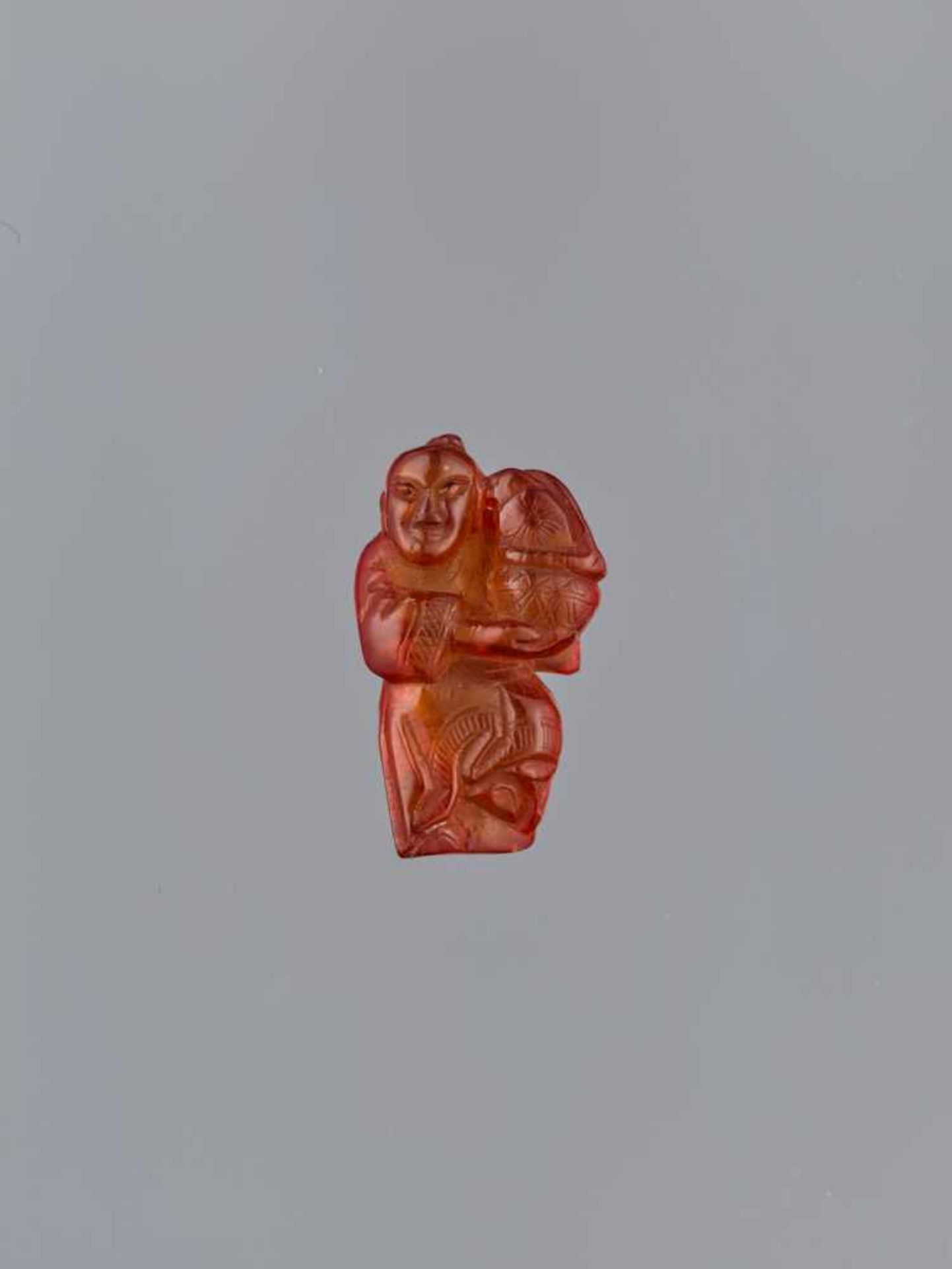 A QING DYNASTY AMBER CARVING OF BOY WITH BASKET Amber of bright orange color and of near translucent - Image 2 of 7