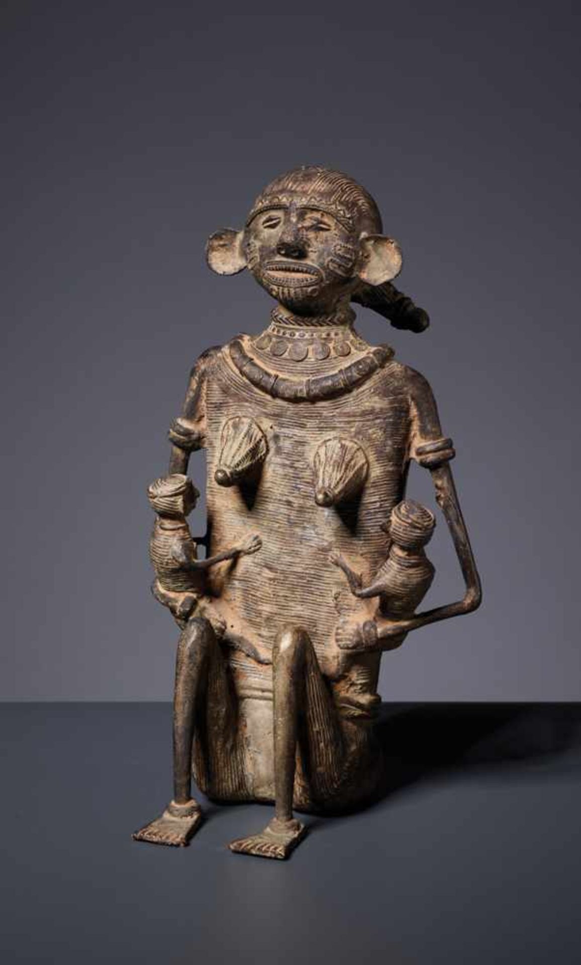 A LARGE KONDH TRIBAL BRONZE OF A MOTHER WITH TWO CHILDREN Copper bronze Northern India, Kondh Tribe,