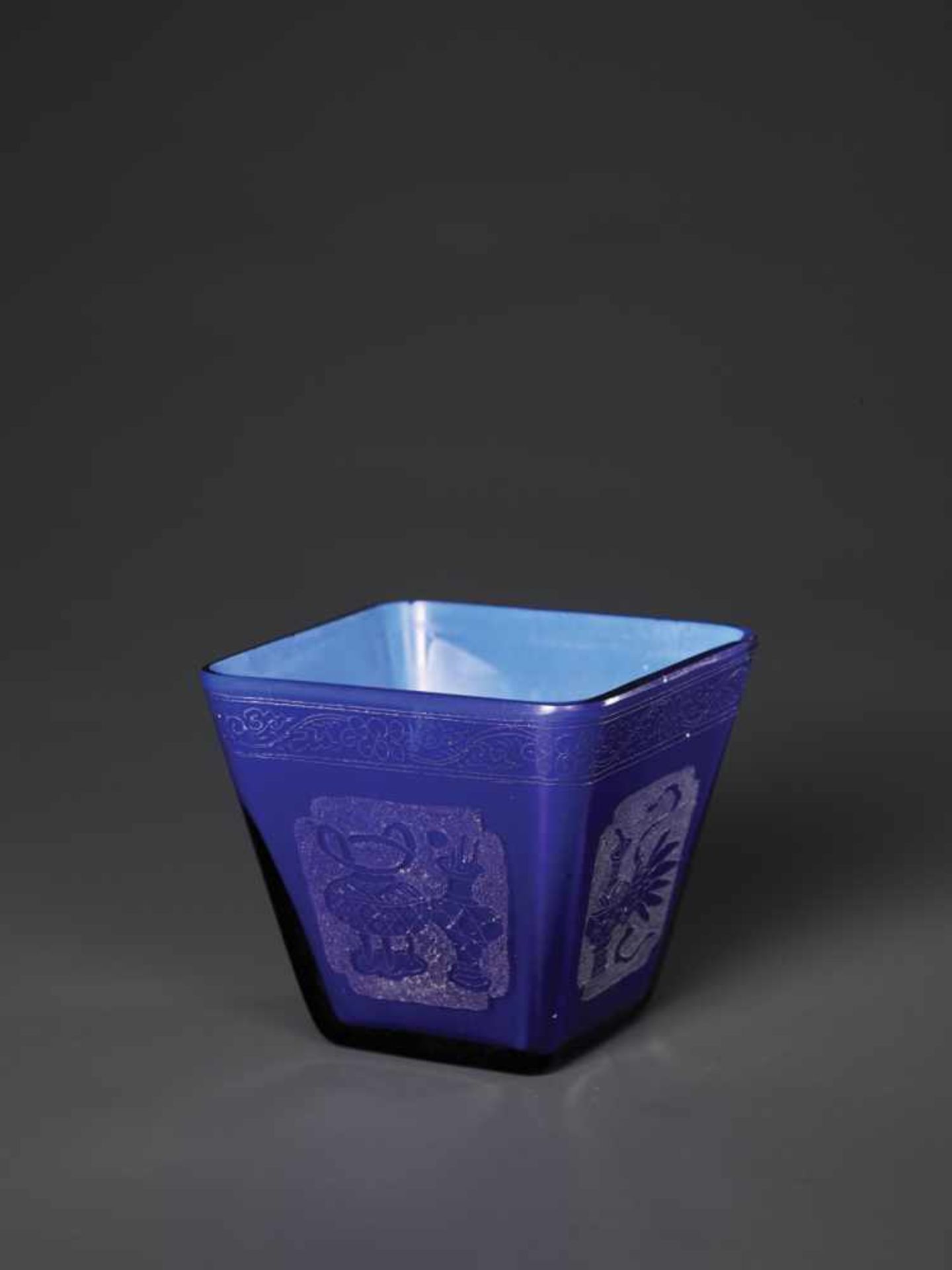 AN ETCHED AND DIAMOND-ENGRAVED SAPPHIRE-BLUE OVERLAY GLASS CUP, KANGXI, 1696-1715 The square-