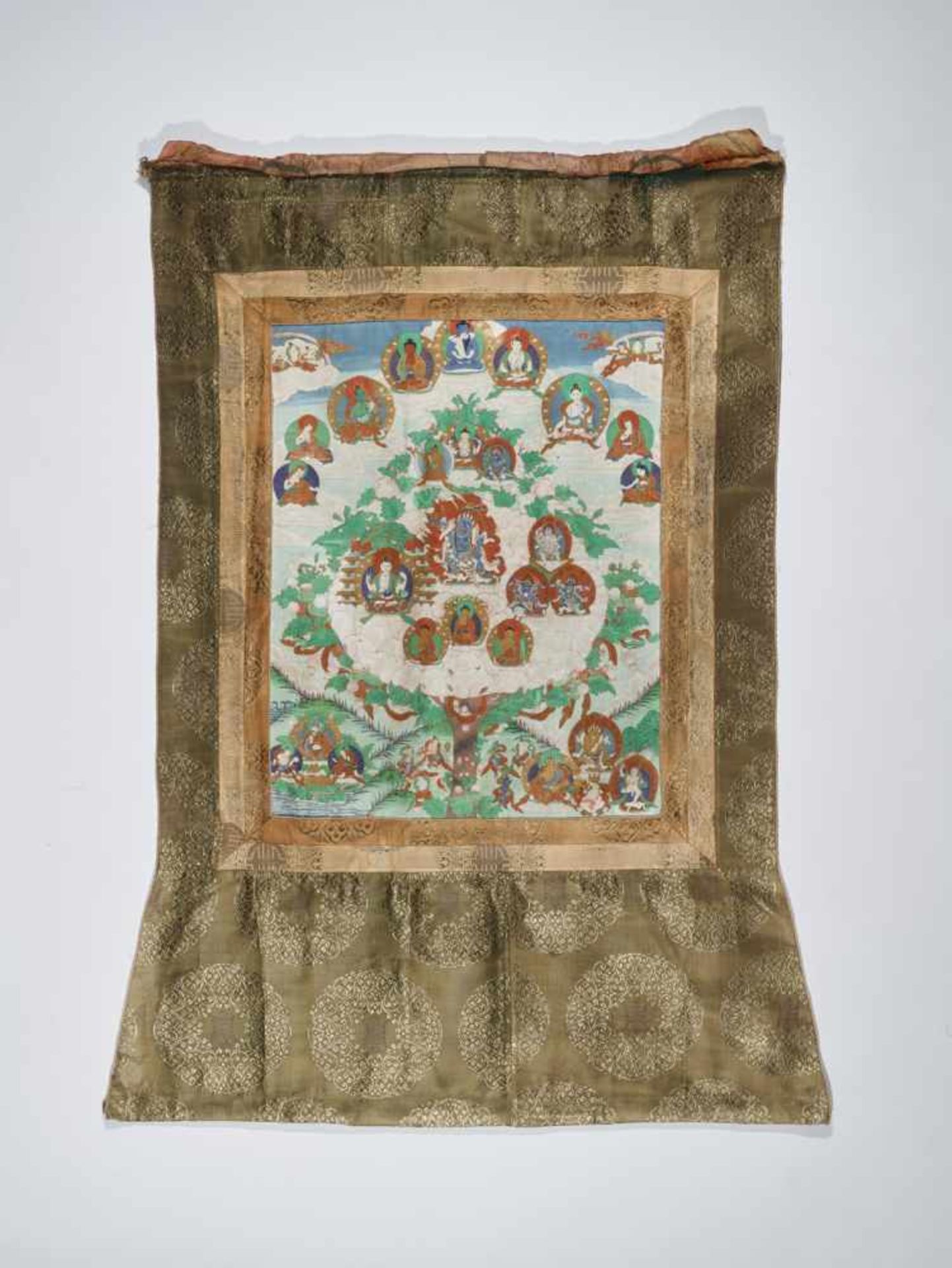 A FINE THANGKA WITH DEITIES IN LOTUS TREE Distemper and gold paint on cloth, framed by segmented - Image 5 of 7