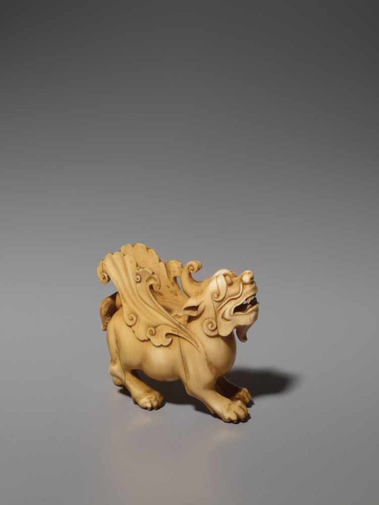 AN IVORY CARVING OF A MYTHICAL BEAST, BIXIE, QING DYNASTY Carved and incised elephant ivory with a