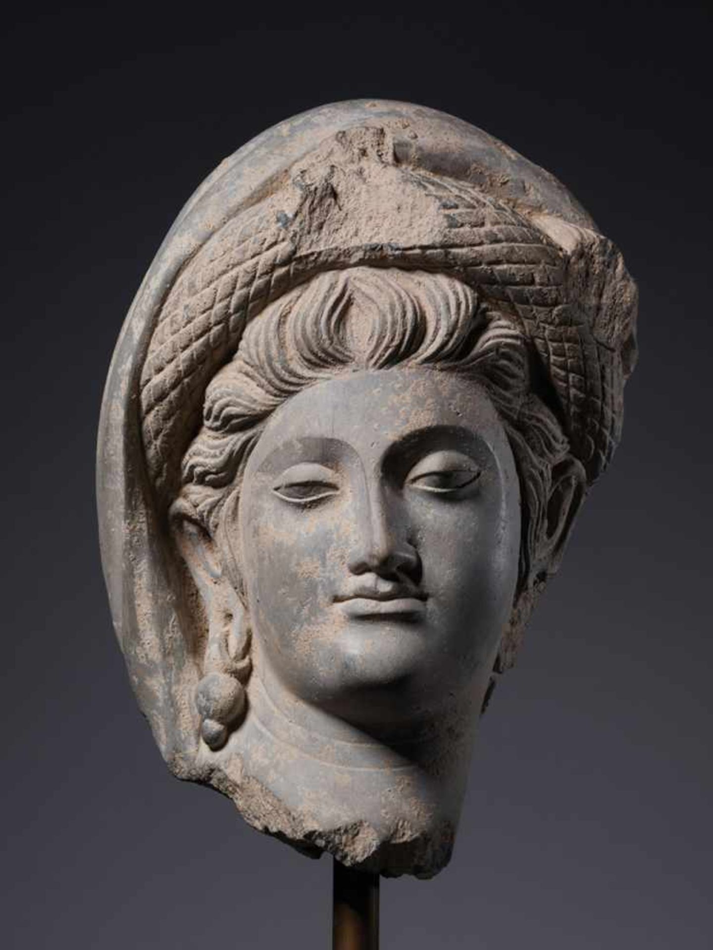 A LARGE GANDHARA SCHIST HEAD OF GODDESS HARITI, 2nd – 3rd CENTURY Grey schist with good age-