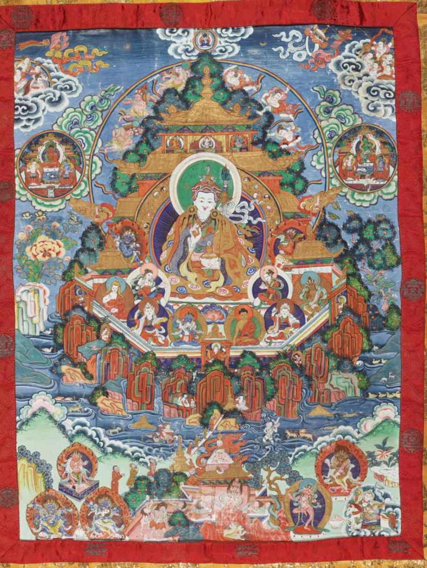 A MAGNIFICENT THANGKA OF GURU RINPOCHE IN ZANGDOK PALRI Distemper and gold paint on cloth, framed by