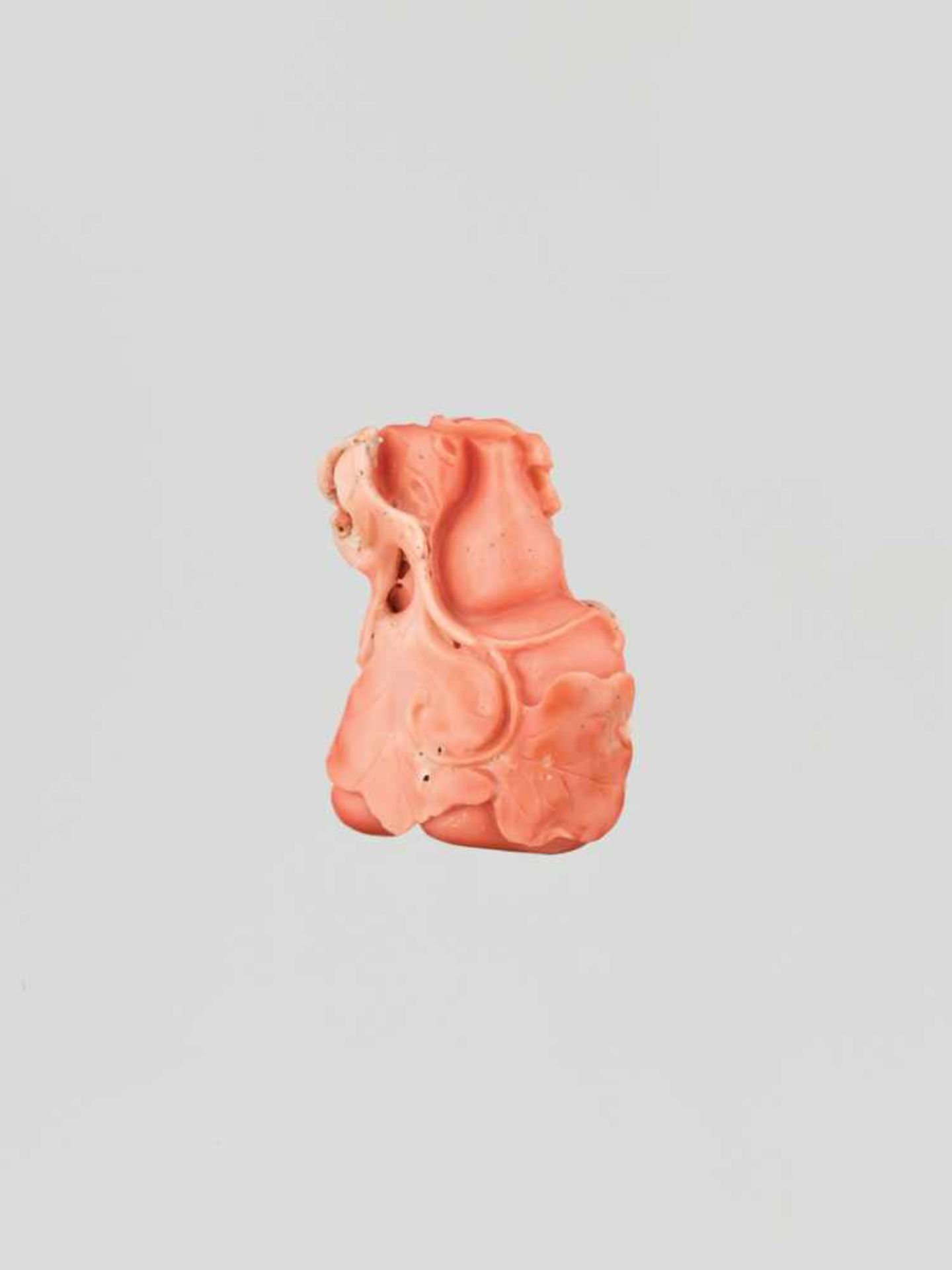 A CARVED CORAL ‘DOUBLE GOURD AND BAT’ PENDANT, QING DYNASTY The material of elegant light red