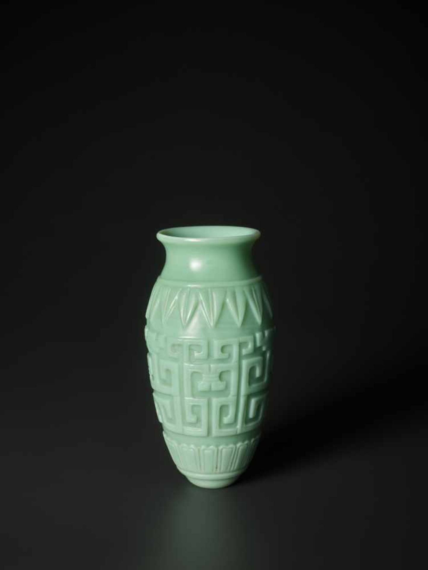 A RARE CARVED ARCHAISTIC ‘KUILONG’ TURQUOISE GLASS VASE, MID QING DYNASTY The translucent glass body