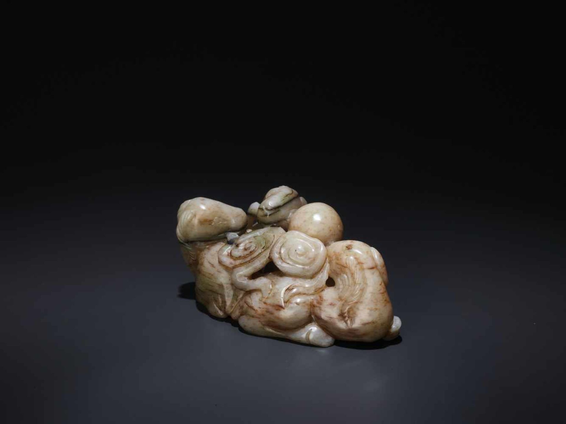 A CHICKEN BONE ‘SAN YANG’ THREE RAMS JADE GROUP, 17TH CENTURY The greyish-white nephrite suffused