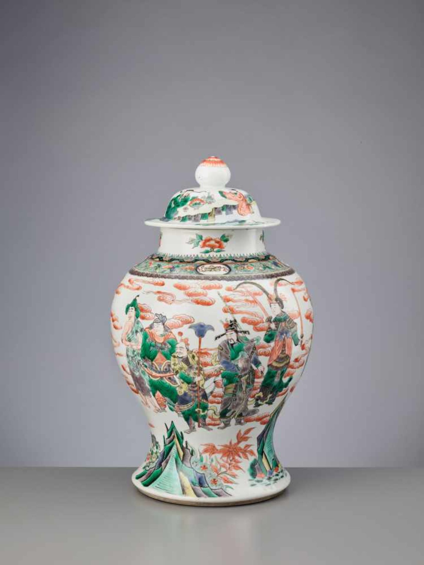 A LIDDED QING DYNASTY FAMILLE VERTE BALUSTER JAR ‘EIGHT IMMORTALS’ Porcelain with iron red,