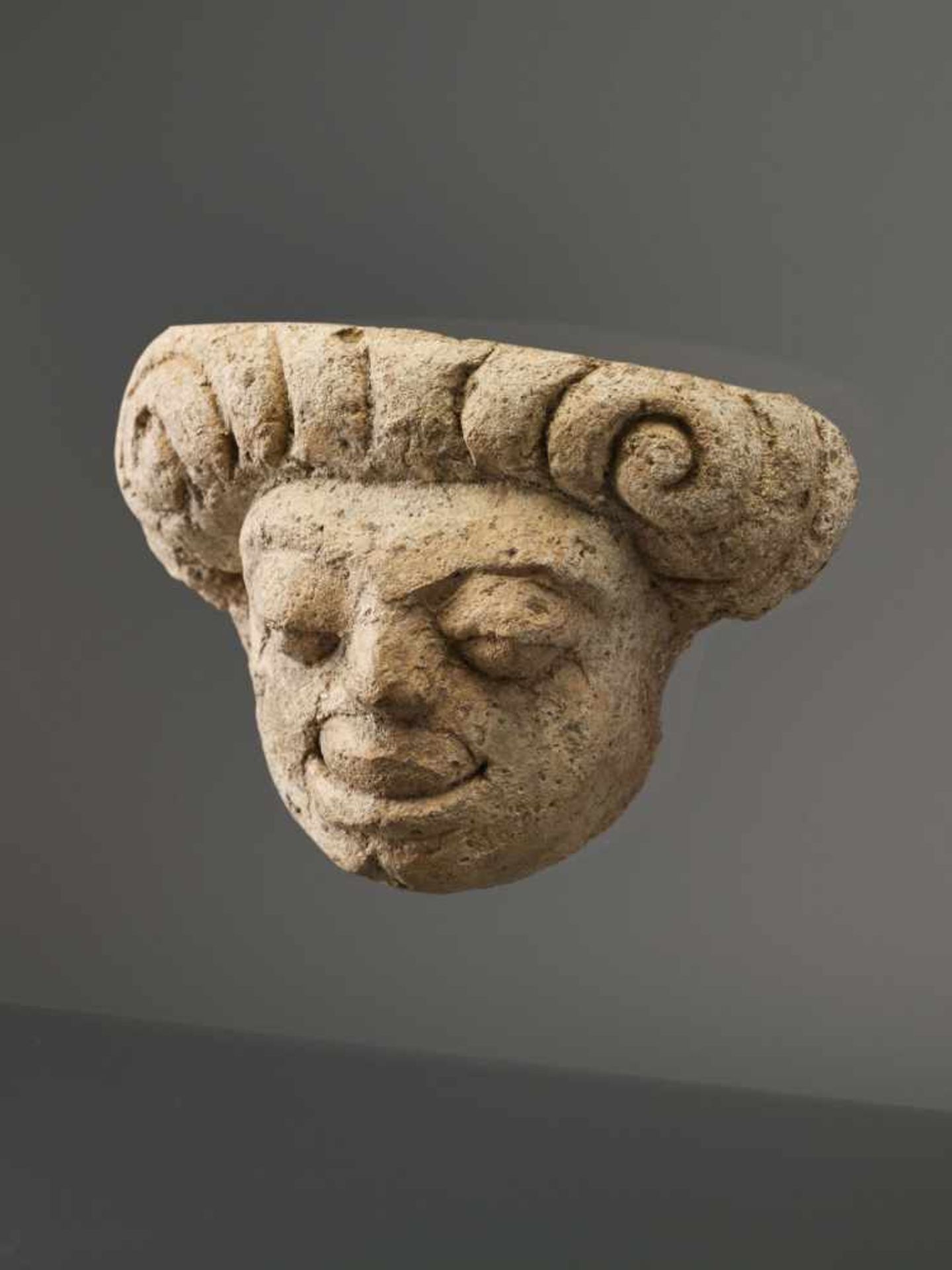 A MON-DVARAVATI STUCCO MASK OF A GROTESQUE MAN, 8th / 9th CENTURY Stucco, firmly mounted to modern