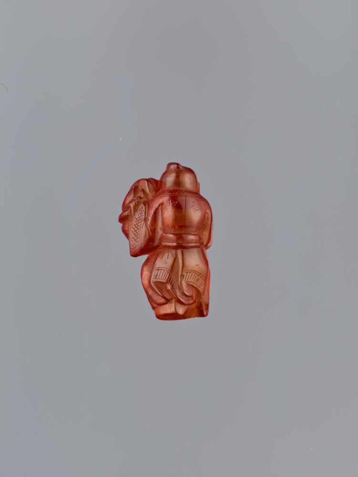 A QING DYNASTY AMBER CARVING OF BOY WITH BASKET Amber of bright orange color and of near translucent - Image 3 of 7