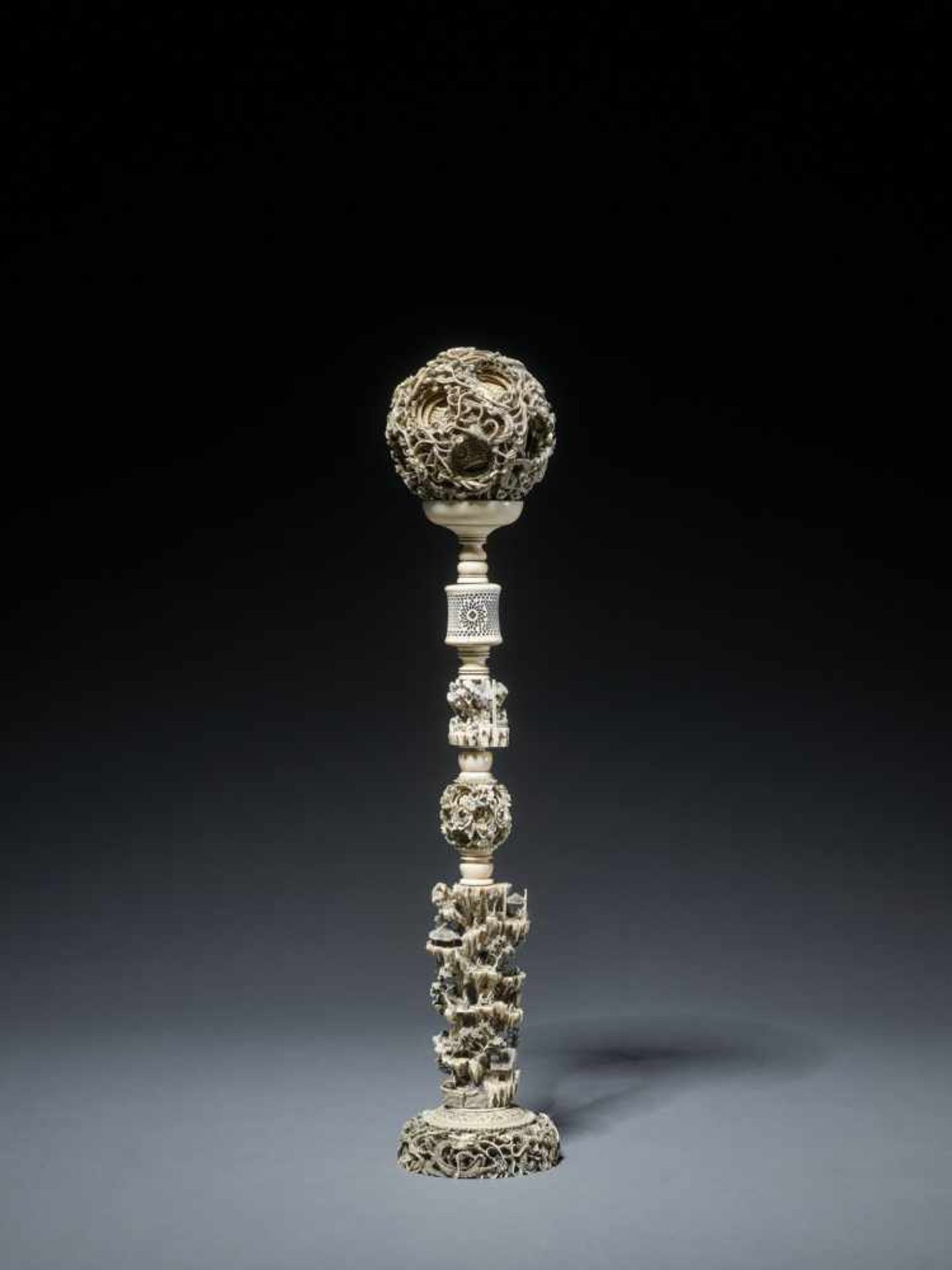 AN IMPORTANT CANTON SCHOOL ‘21-LAYER’ MAGIC IVORY BALL ON A TALL STAND, QING DYNASTY Carved ivory