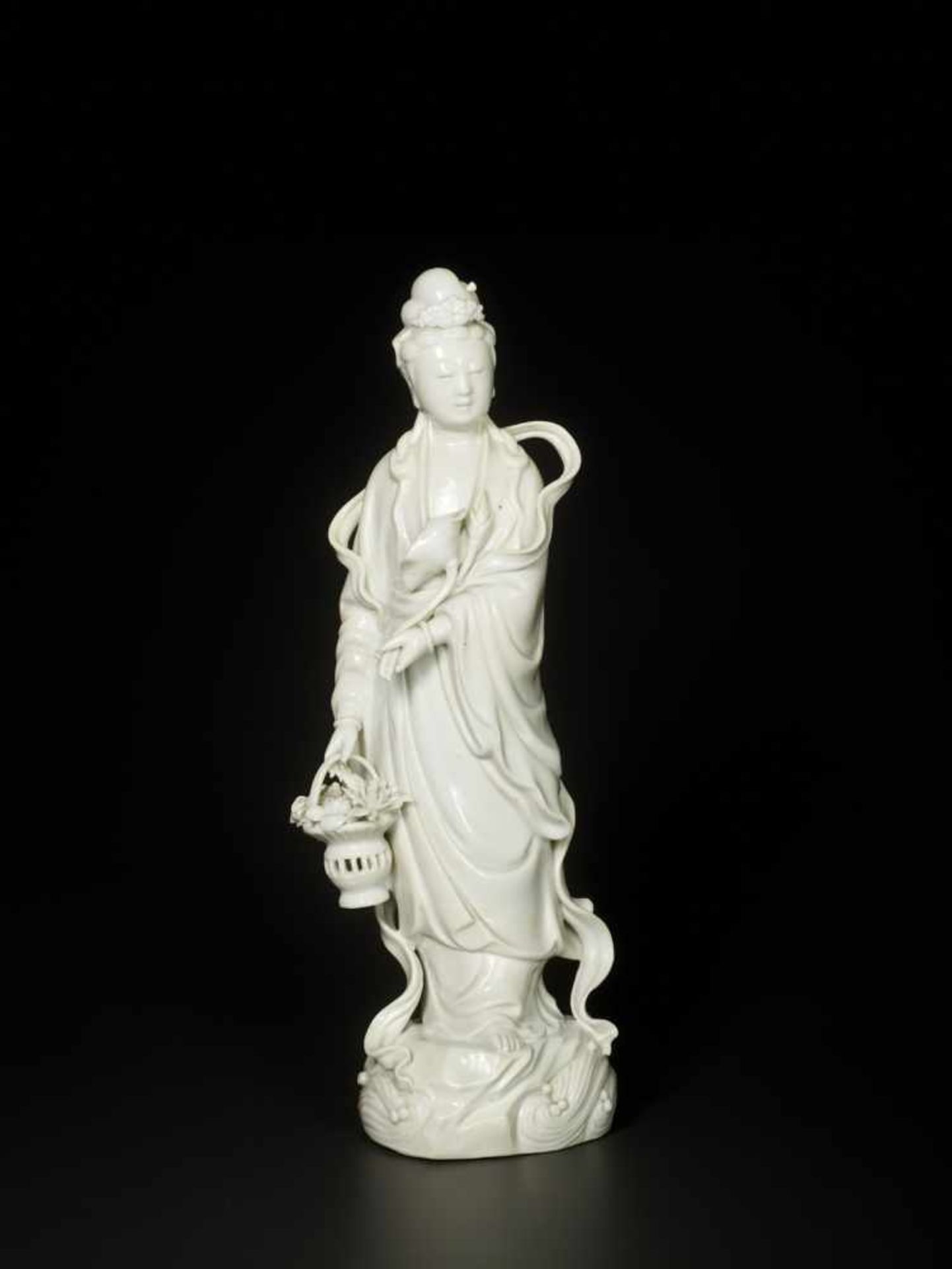 A BLANC-DE-CHINE PORCELAIN FIGURE OF GUANYIN, QING DYNASTY, DEHUA Molded white porcelain with carved