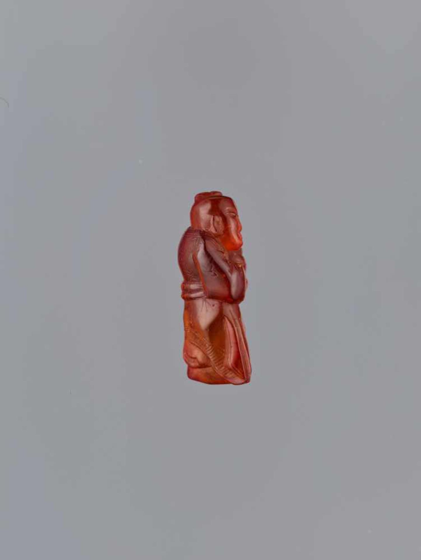 A QING DYNASTY AMBER CARVING OF BOY WITH BASKET Amber of bright orange color and of near translucent - Image 5 of 7