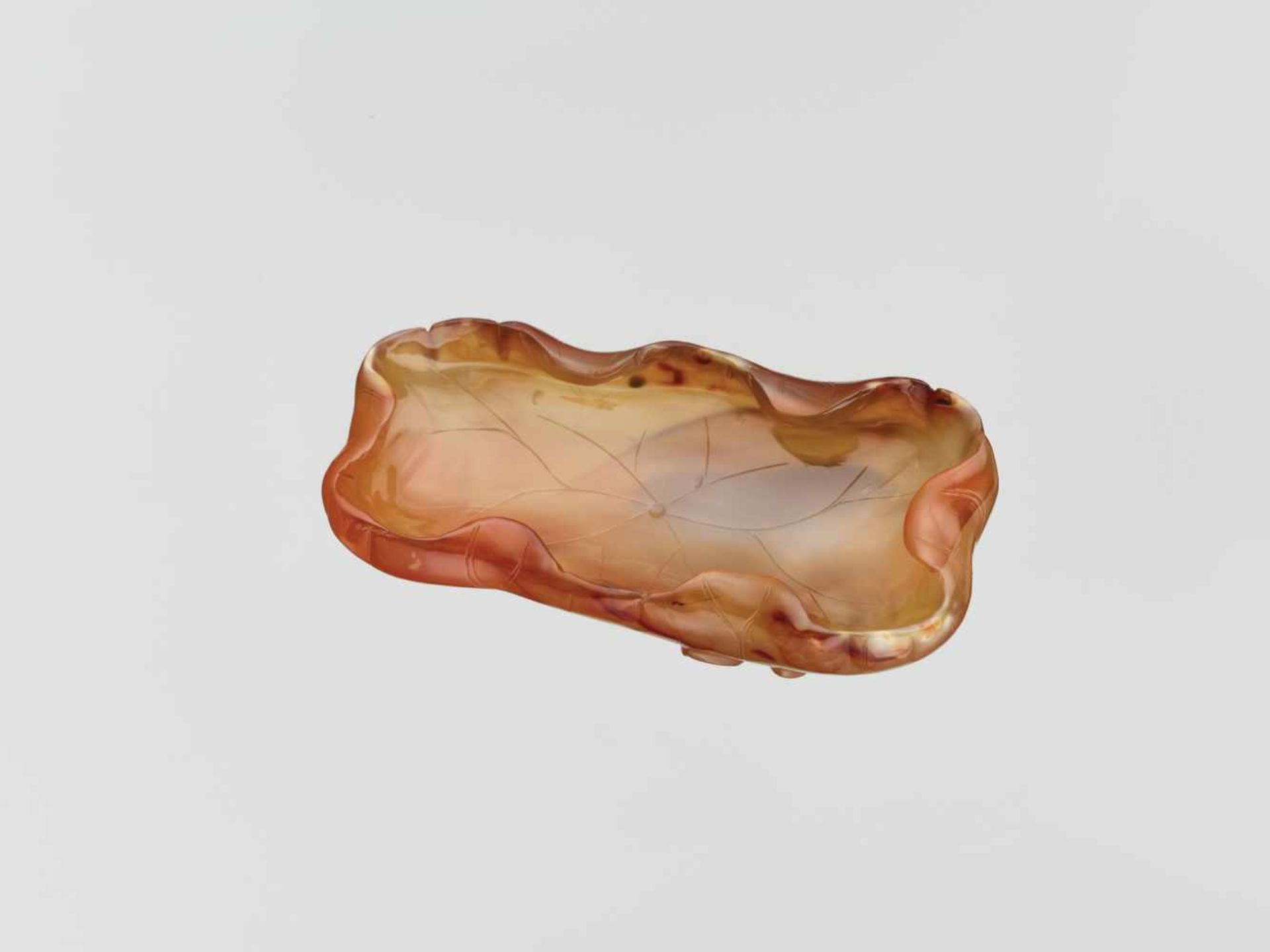 A CARVED AGATE ‘LOTUS’ WASHER QING DYNASTY, 18TH CENTURY Translucent agate of golden-brown and amber