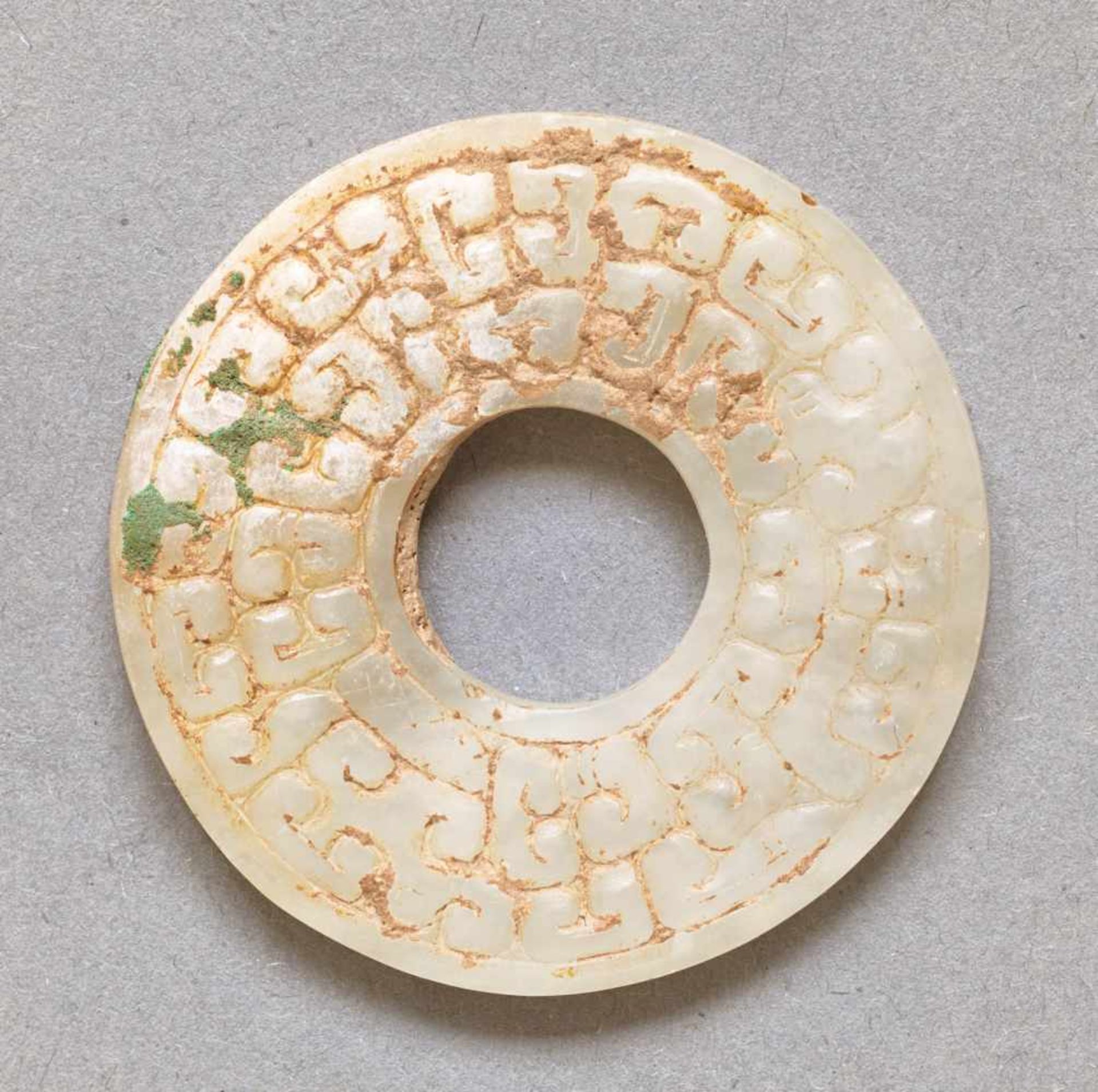 SMALL DISC WITH DRAGON HEADS AND PATTERN OF CLOUDSHAPED CURLS JUANYUN This jade is published in - Image 2 of 5