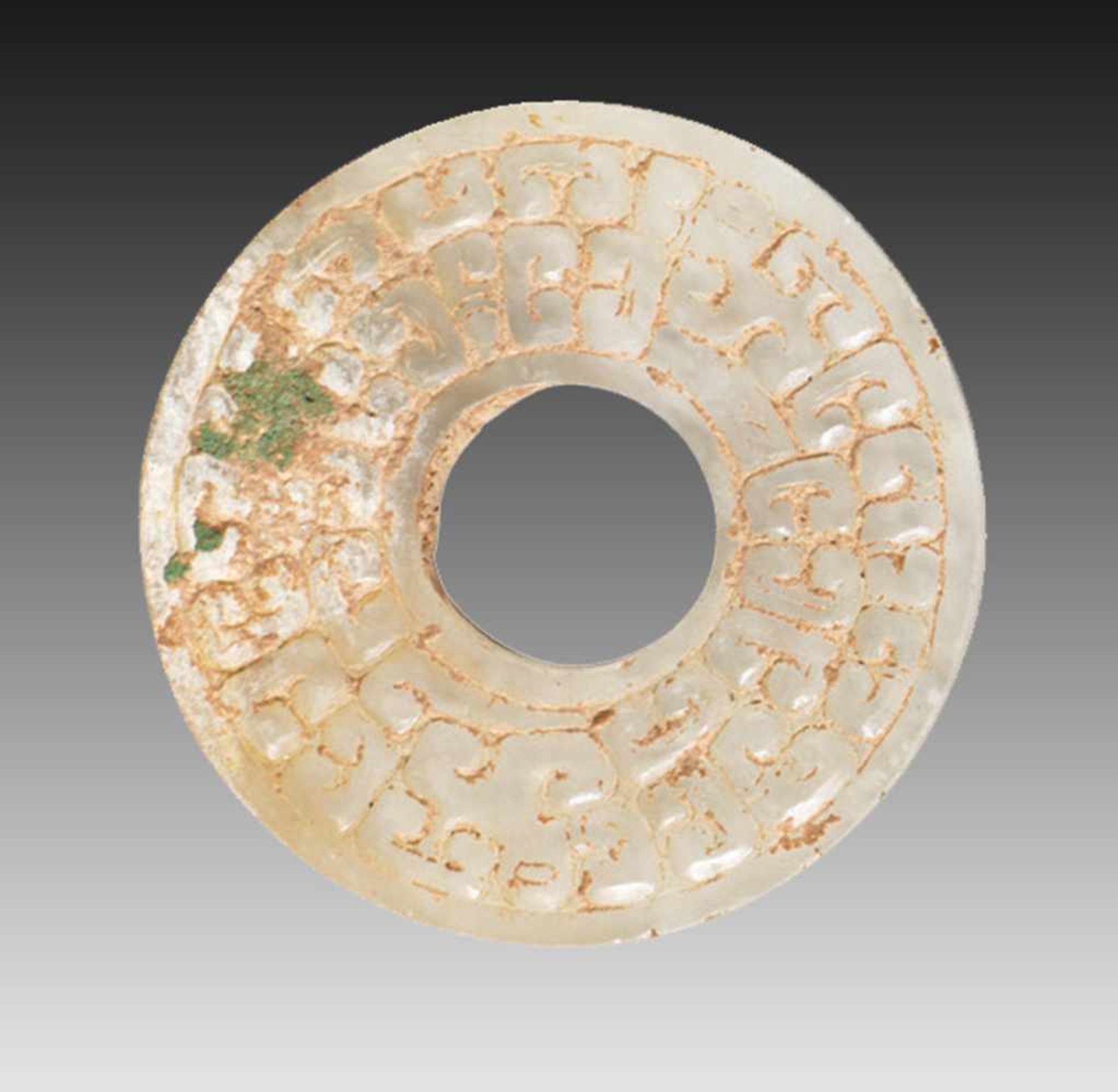 SMALL DISC WITH DRAGON HEADS AND PATTERN OF CLOUDSHAPED CURLS JUANYUN This jade is published in