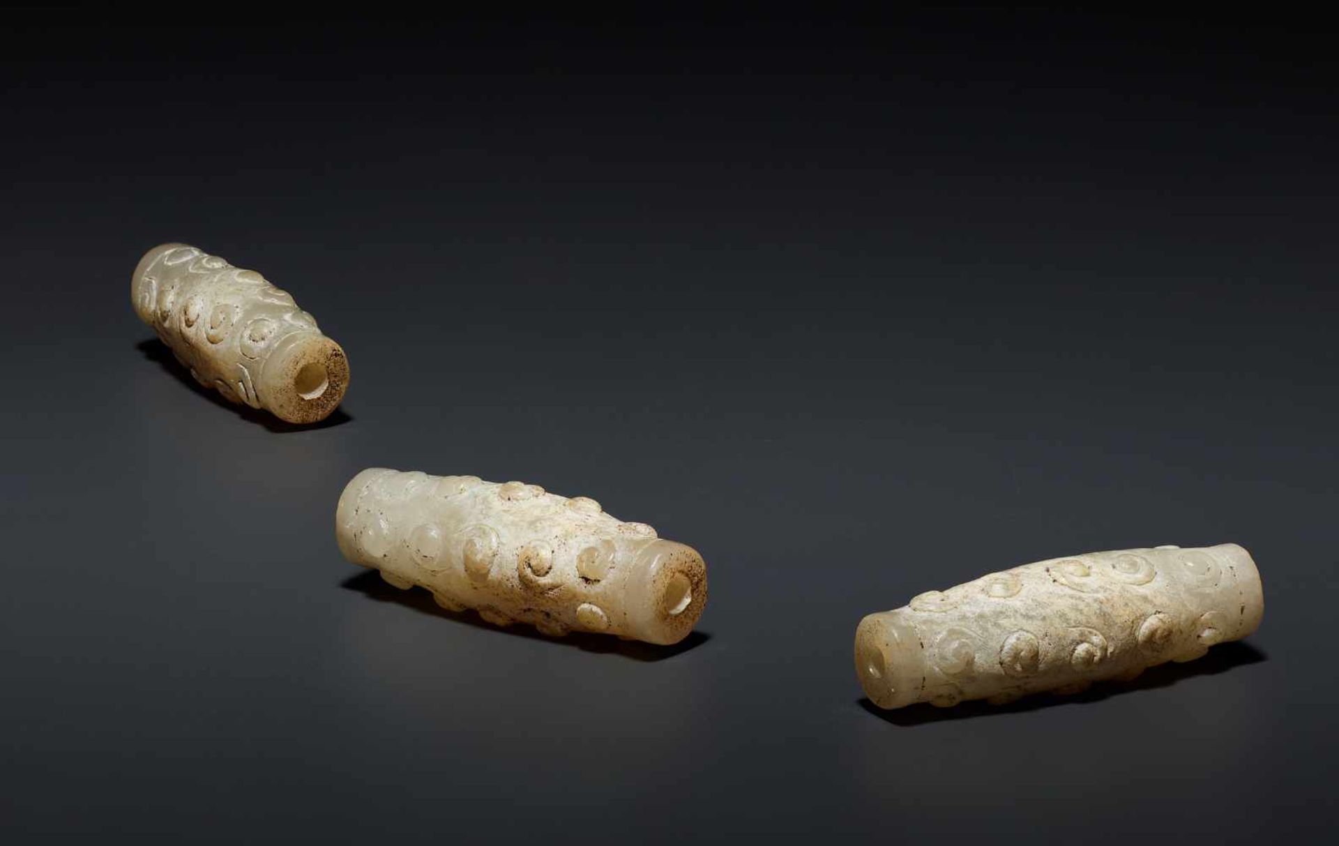 THREE BEADS WITH PATTERN OF RAISED CURLS This jade is published in Filippo Salviati 4000 YEARS OF