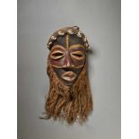 AN INITIATION MASK, CÔTE D’IVOIRE / LIBERIA, DAN PEOPLEWood with painted metal, fabric, raffia,